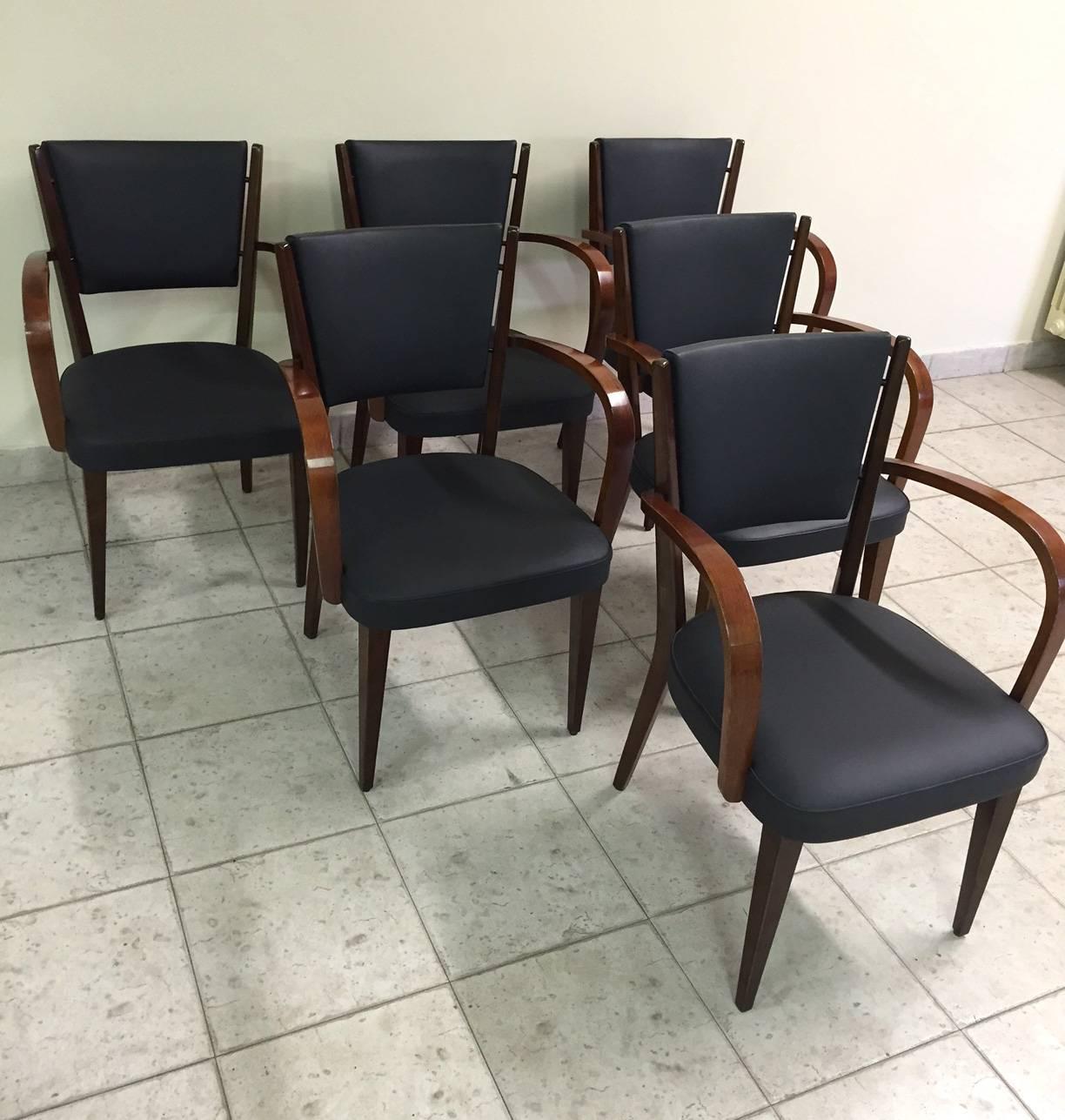 This set of six armchairs was designed and produced in Italy in the 1950s. The are made from walnut with new leather upholstery.