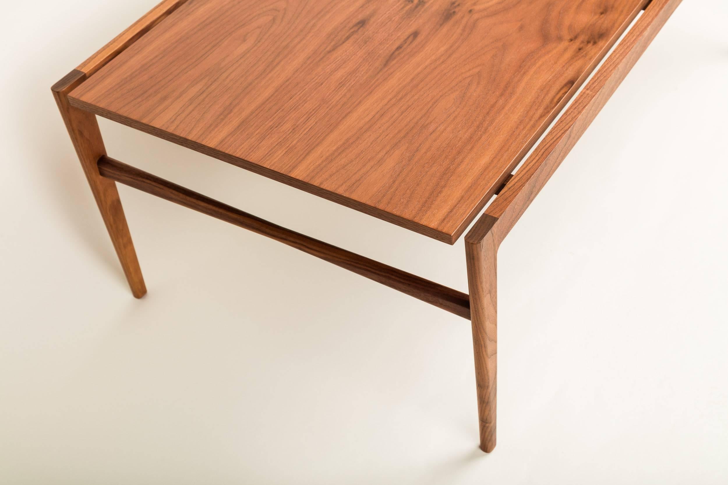 Lilian Coffee Table 1 by Matthew Ryan for MaxWood Co.

This handmade walnut table features a floating top with bookmatched gorgeous flat grain. Delicate features are mixed with sharp subtle lines and angles, inspired by the elegance of black widow