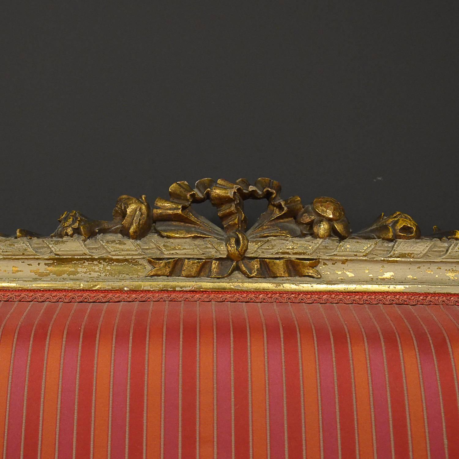 Restored Louis XVI style bench, original restored with red striped fabric.
Manufactured in France during the late 1800s.
