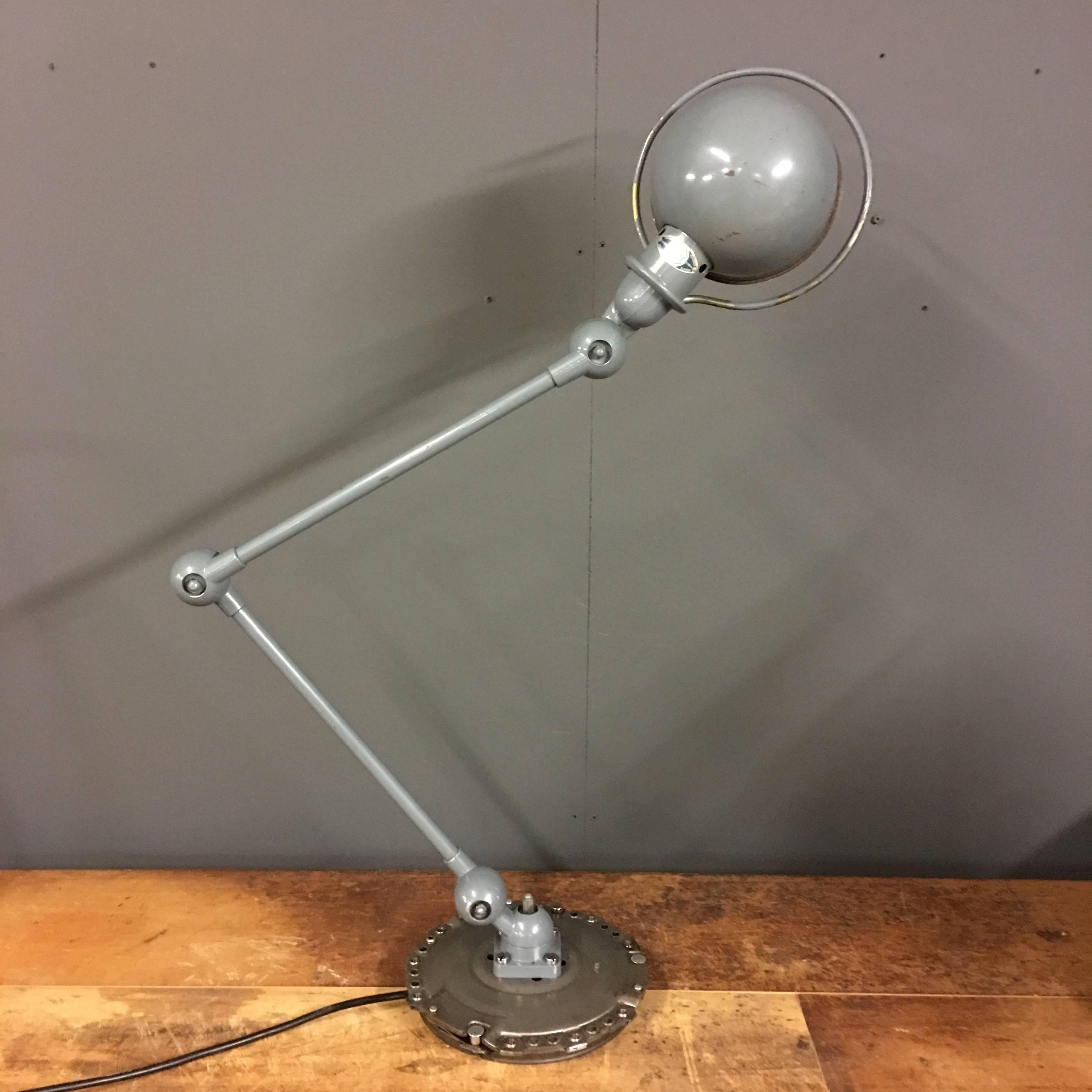 Industrial workshop light by Jean Domecq for Jieldé. Manufactured in France during the 1950s. Adjustable at all joints, converted to E27 socket. This model is mounted on a Metal disc and remains in very good condition.