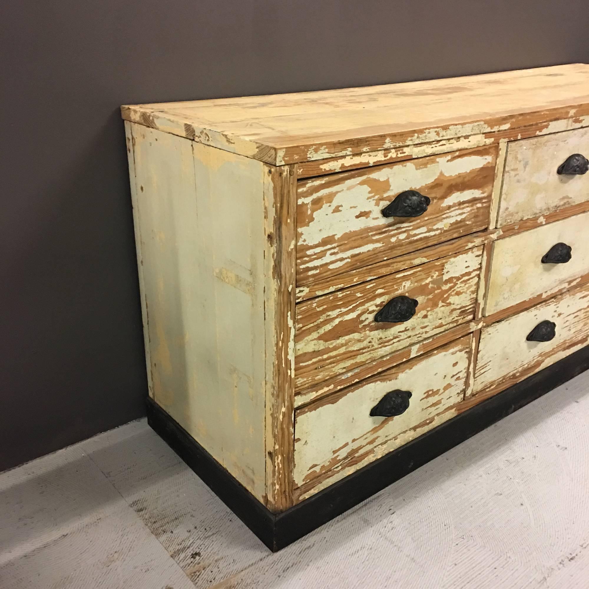 Distressed painted bank of drawers. Nine drawers.