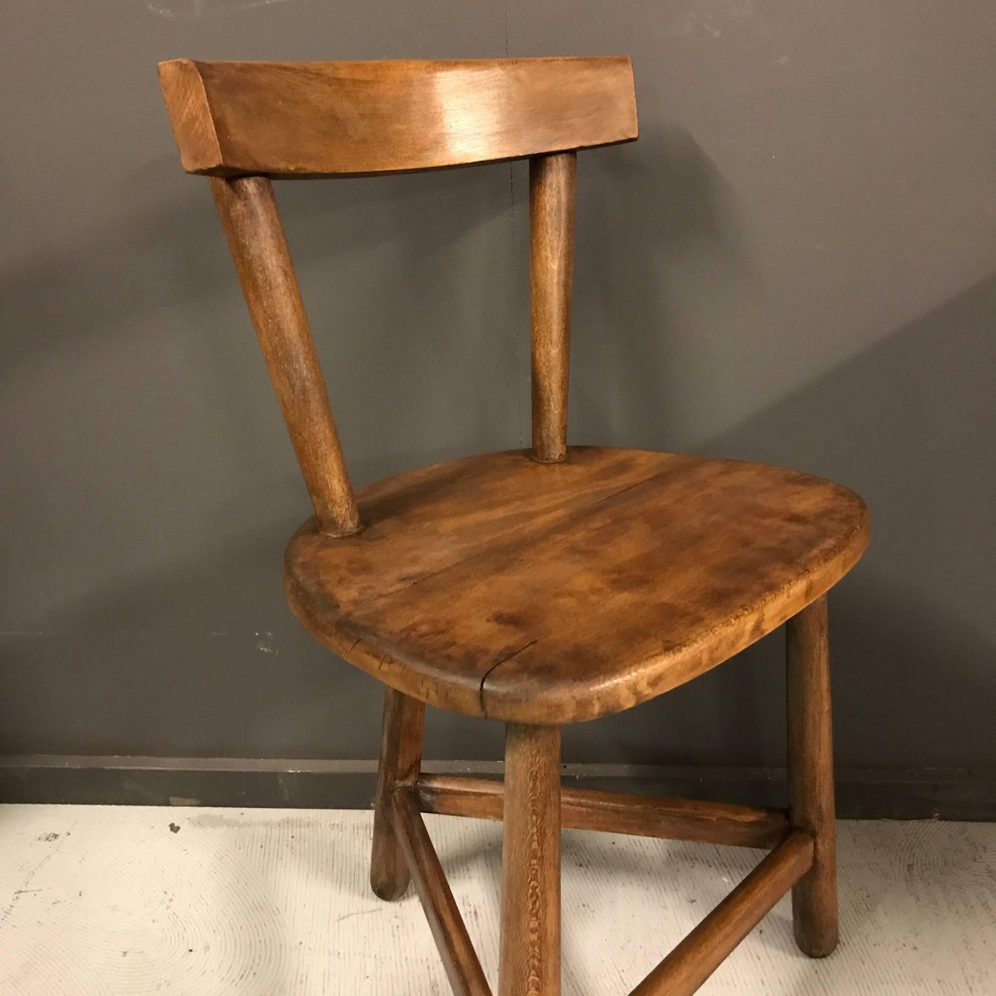 Native beech wooden chair with three legs. 
Probably made in England during the early 20th century.