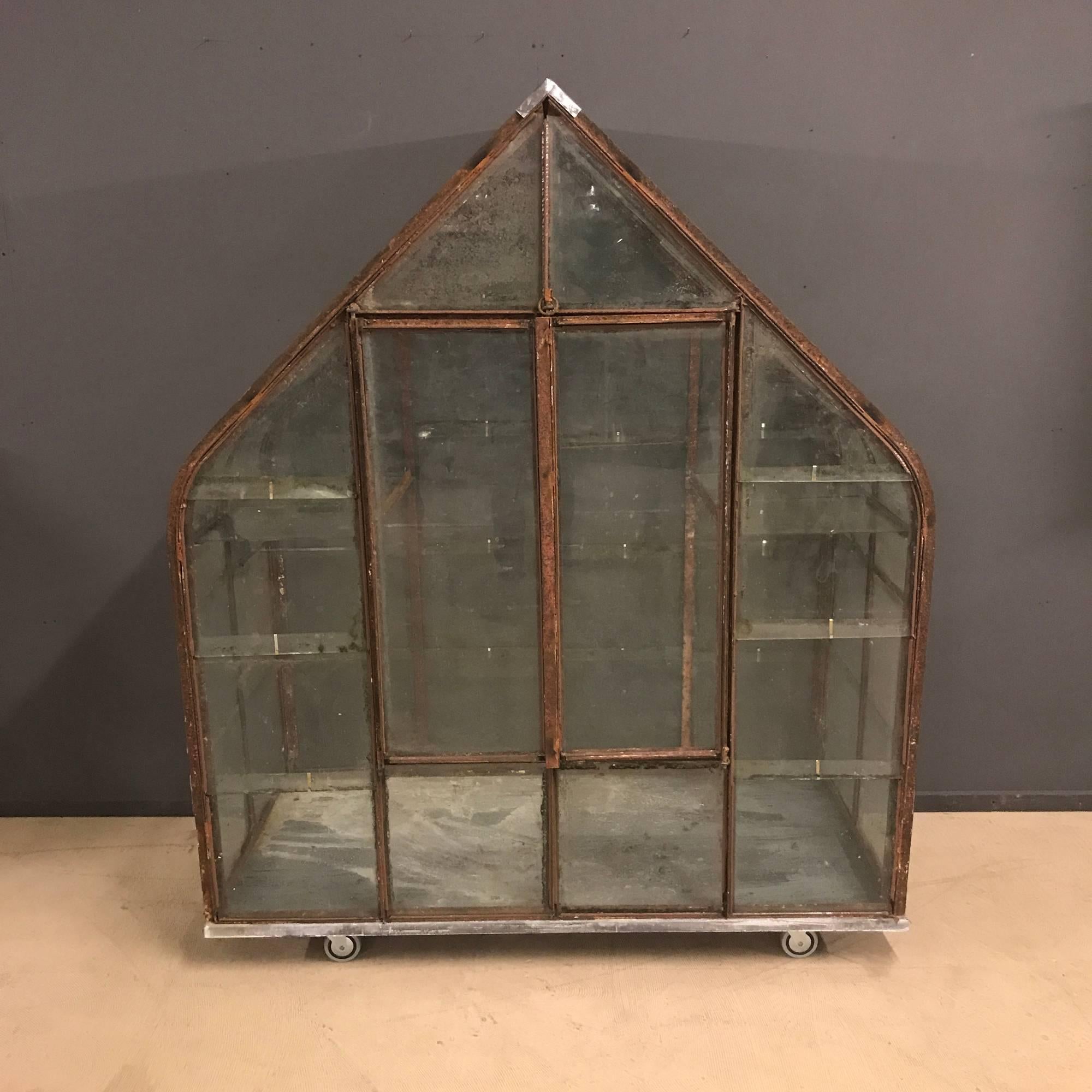 Beautiful small French antique greenhouse. 

The original greenhouse (40meters Long) was made in France during the 1920s.
This greenhouse has two shelves, two doors and four rolls.
Could be used as a greenhouse for herbs.
 