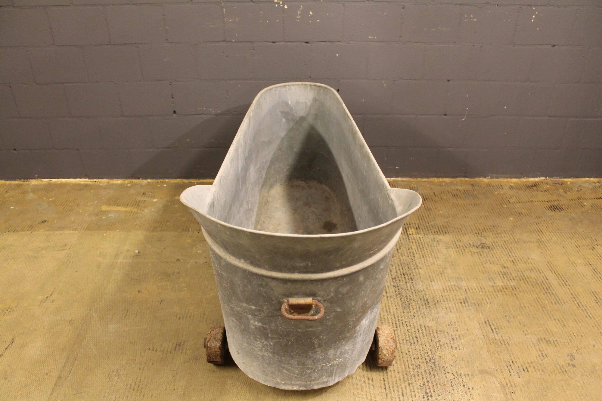 Deep bath made of zinc. Transportable on wooden wheels. Made late 19th century in France.
 