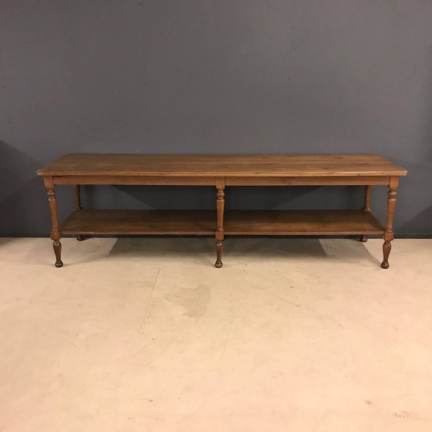 Elegant French antique drapers table. Made of oak in France during the late 19th century. Has been waxed and polished and remains in good condition.