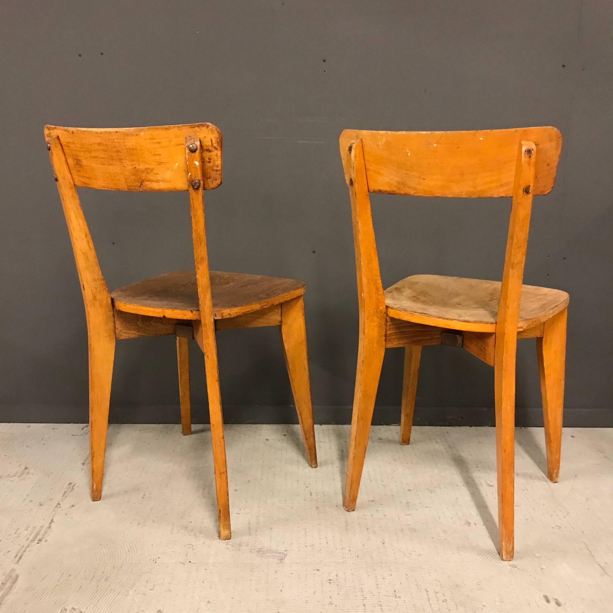 Nice pair of vintage wooden bistro chairs. Made during the early 20th century. Unfortunately one of the seating is damaged. Rest remains in good condition.