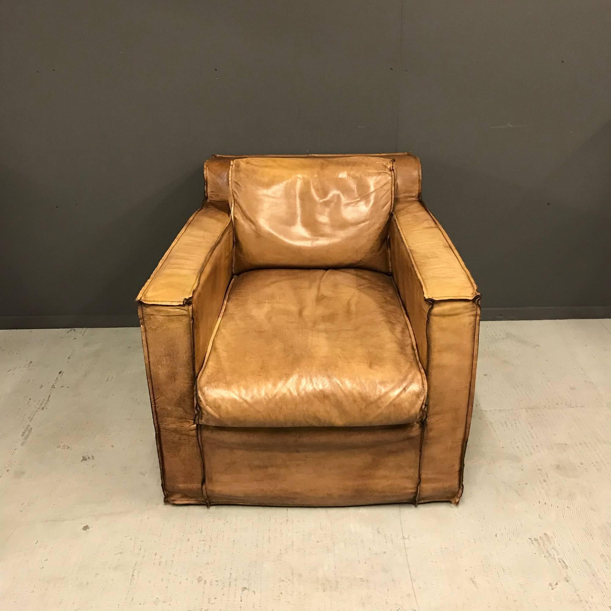 Cognac collored buffalo leather armchair. Unusual shape, with great comfort. This armchair remains in good condition.
