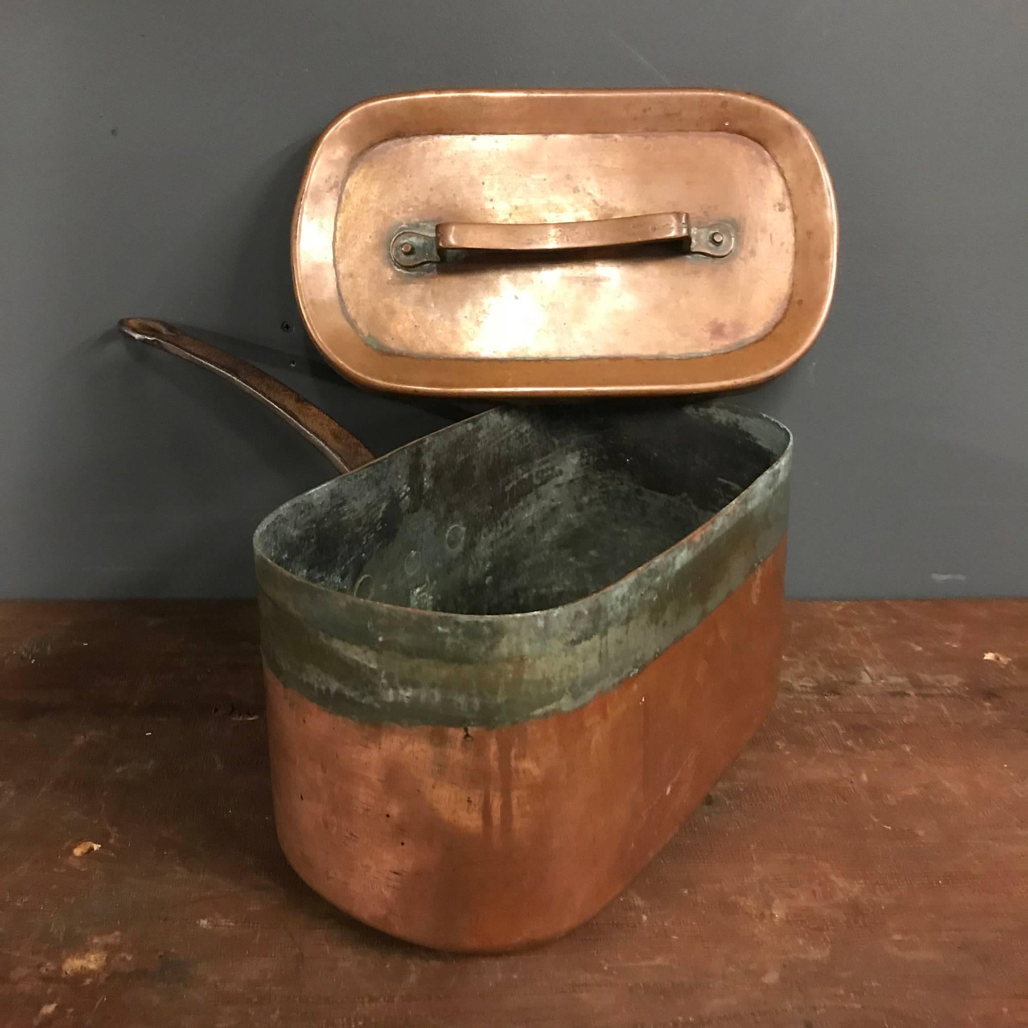 Antique oval copper pan with original flat lid. Remains in good condition.