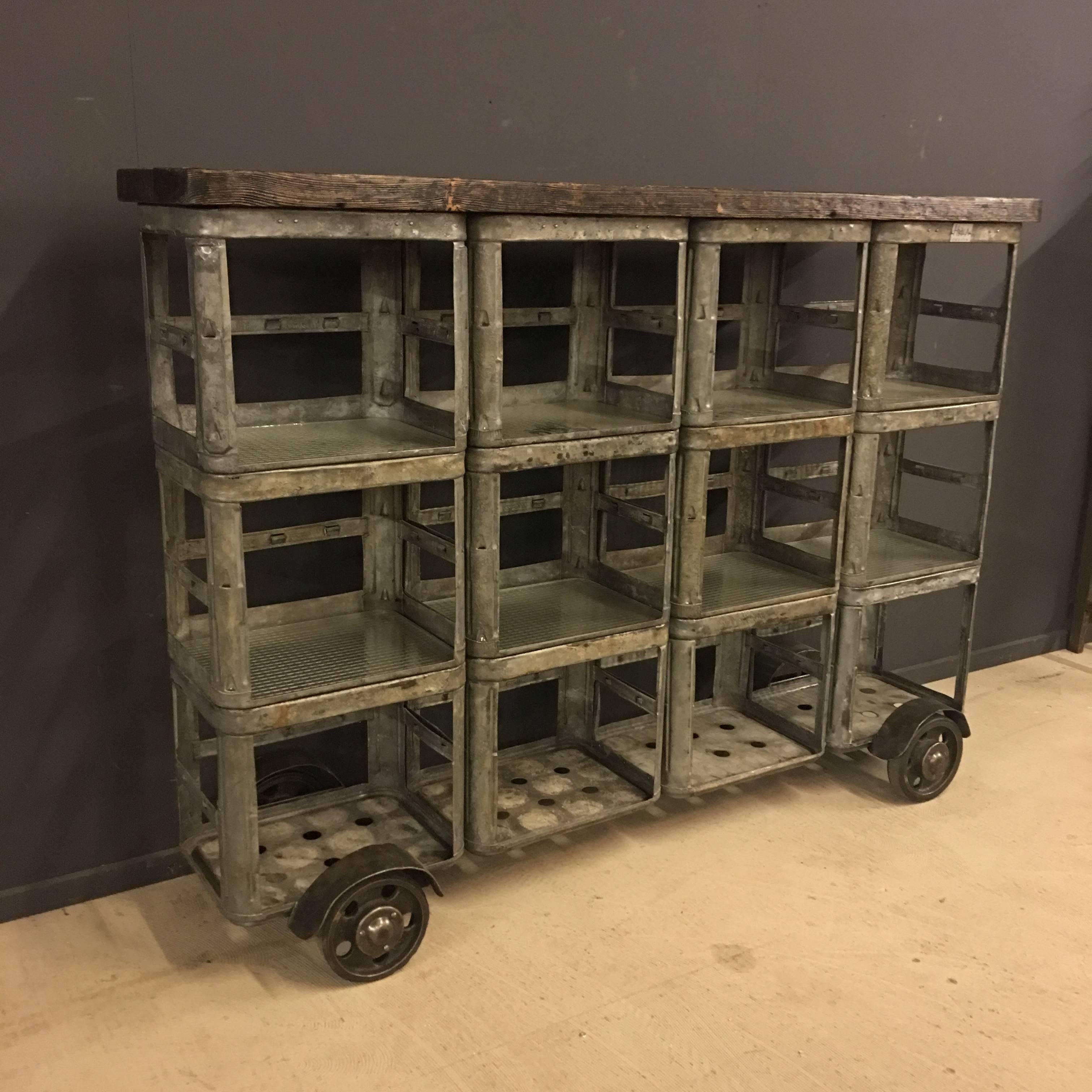 This big Industrial rack is manufactured by HRDLA Design. Made of vintage zinc soda crates used in the 1950s, cast iron wheels and wired glass used as shelves.