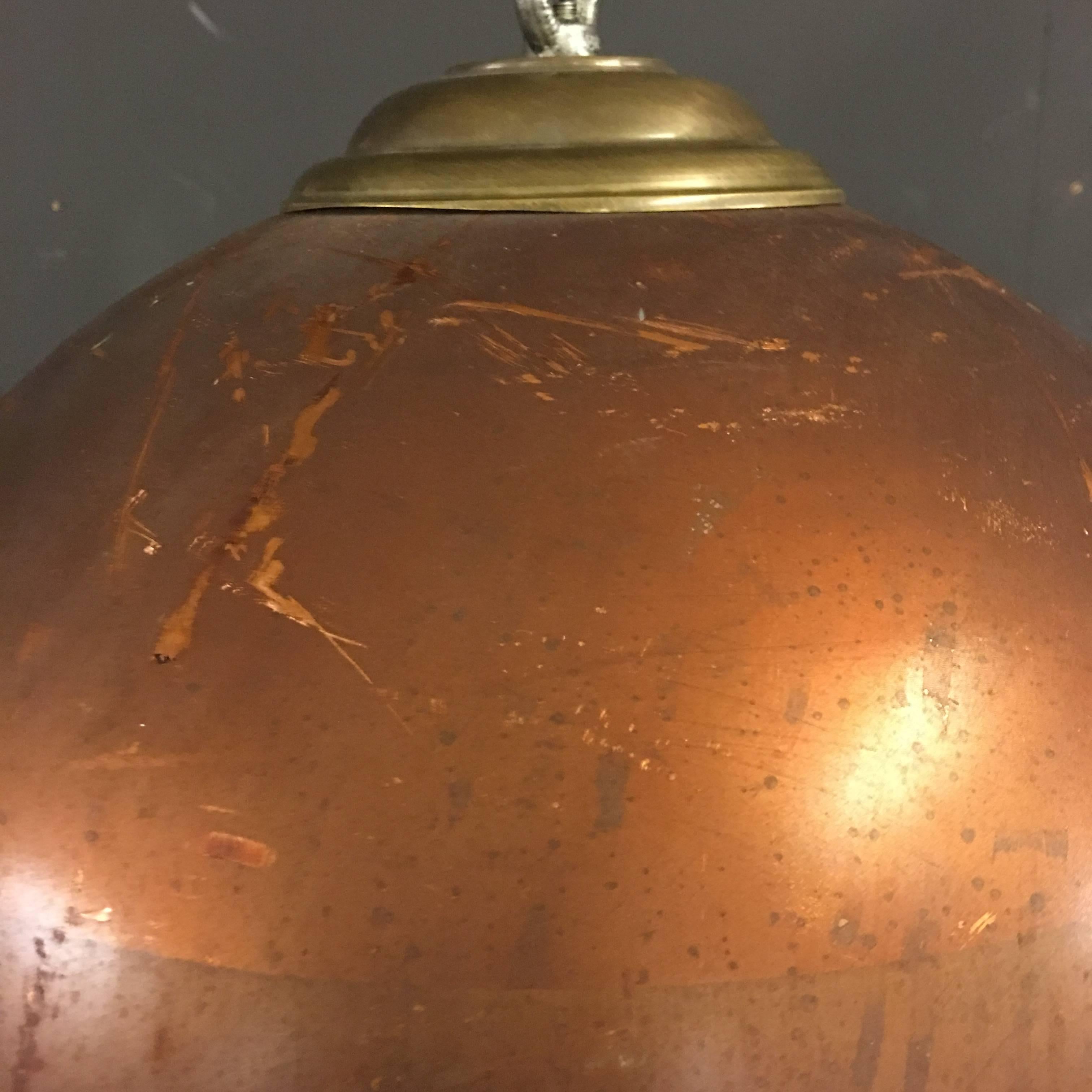 This pair of Industrial copper pendant lights are made of an old water heater. They have a unique warm look. The inside of the shade has been sand blasted.
Features a chain, ceiling cover and an E27 porcelain socket.