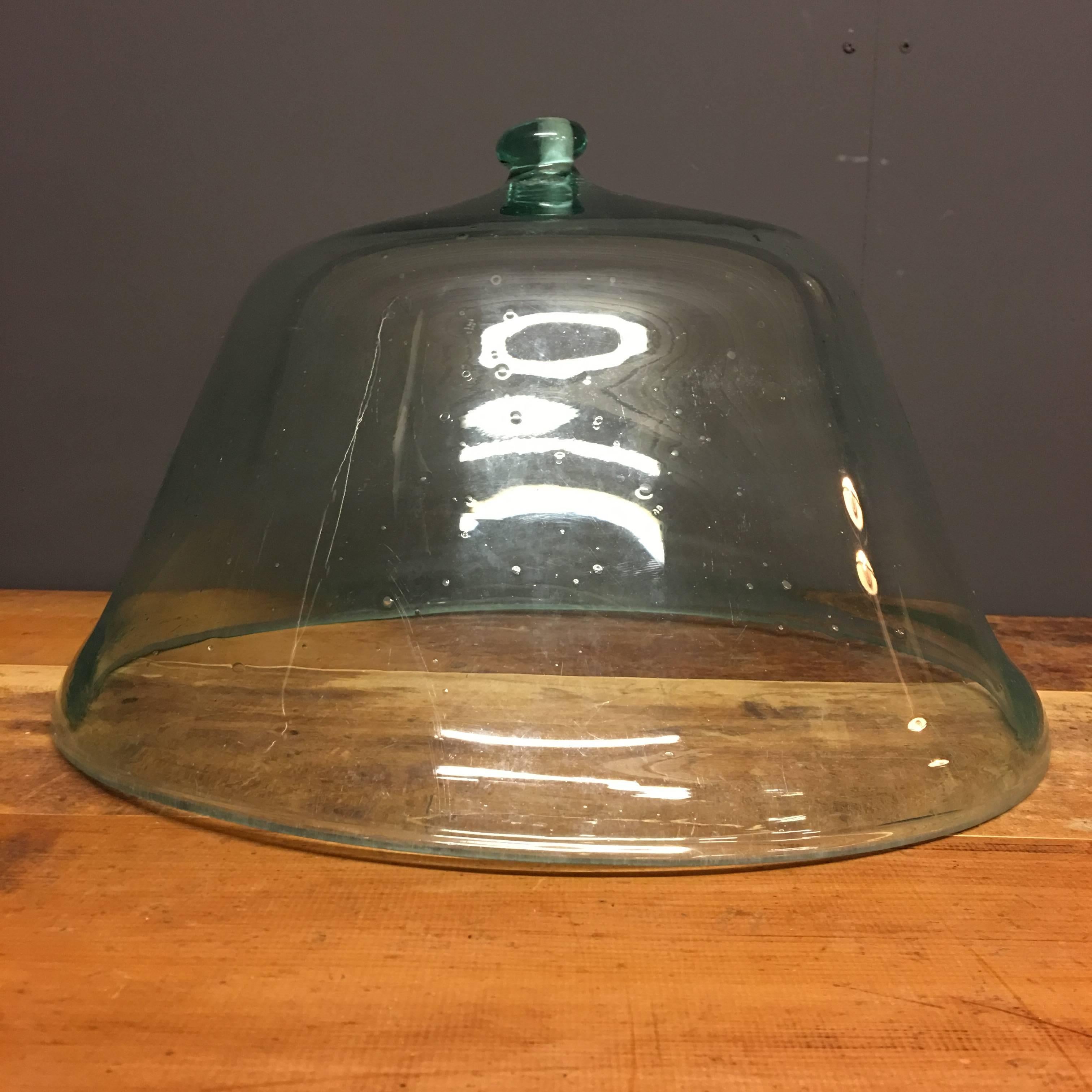 This antique glass garden bell cloche was made in France during the late 19th century. It was handblown as visible due to all the small little bells in the cloche.
This cloche remains in excellent condition.
    