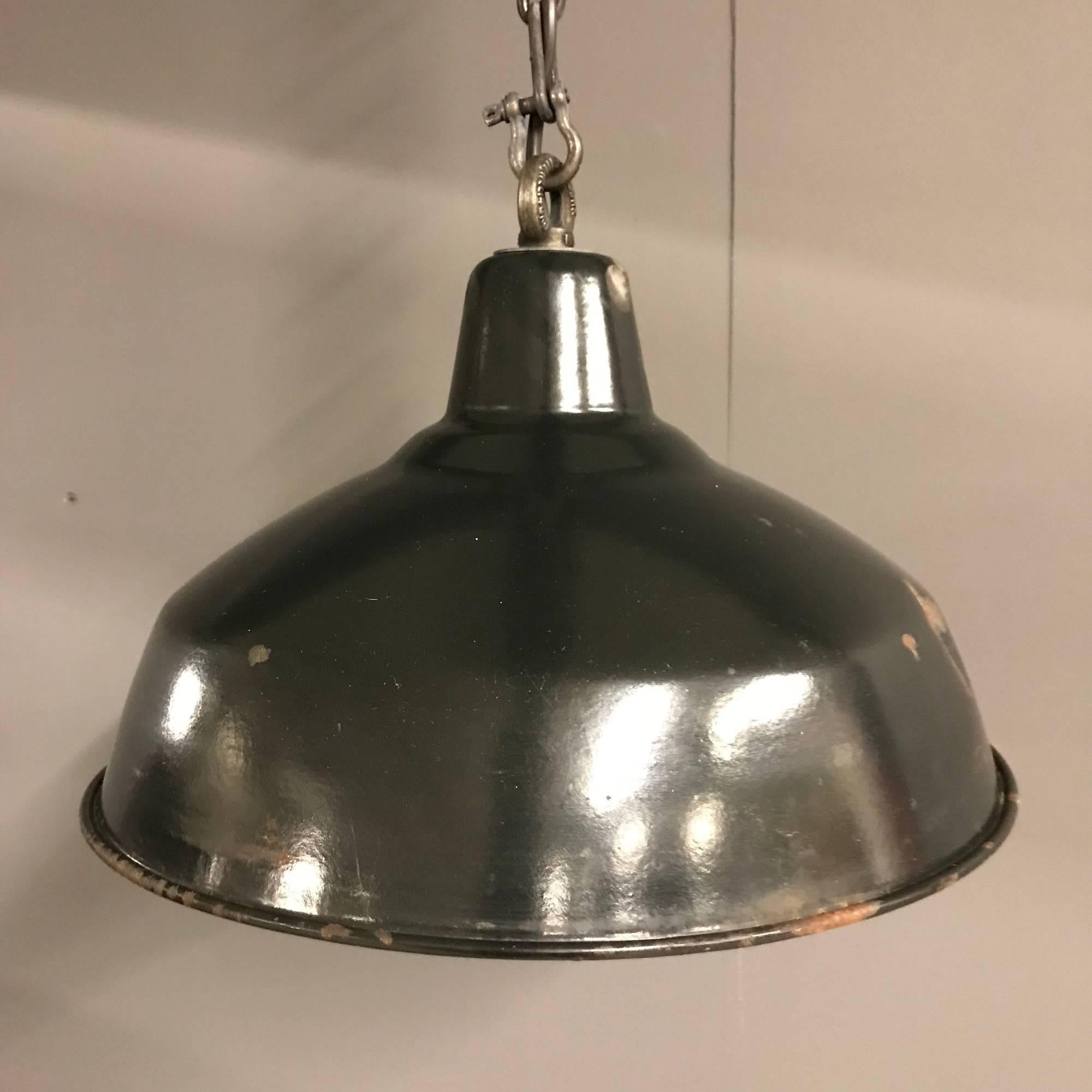 Black enamel factory pendant light. Have been restored and converted to E27 with an porcelain socket. Comes with an 100 cm long patinated chain. Two pieces available, price each.
Size of this two piece small black enamel factory pendant