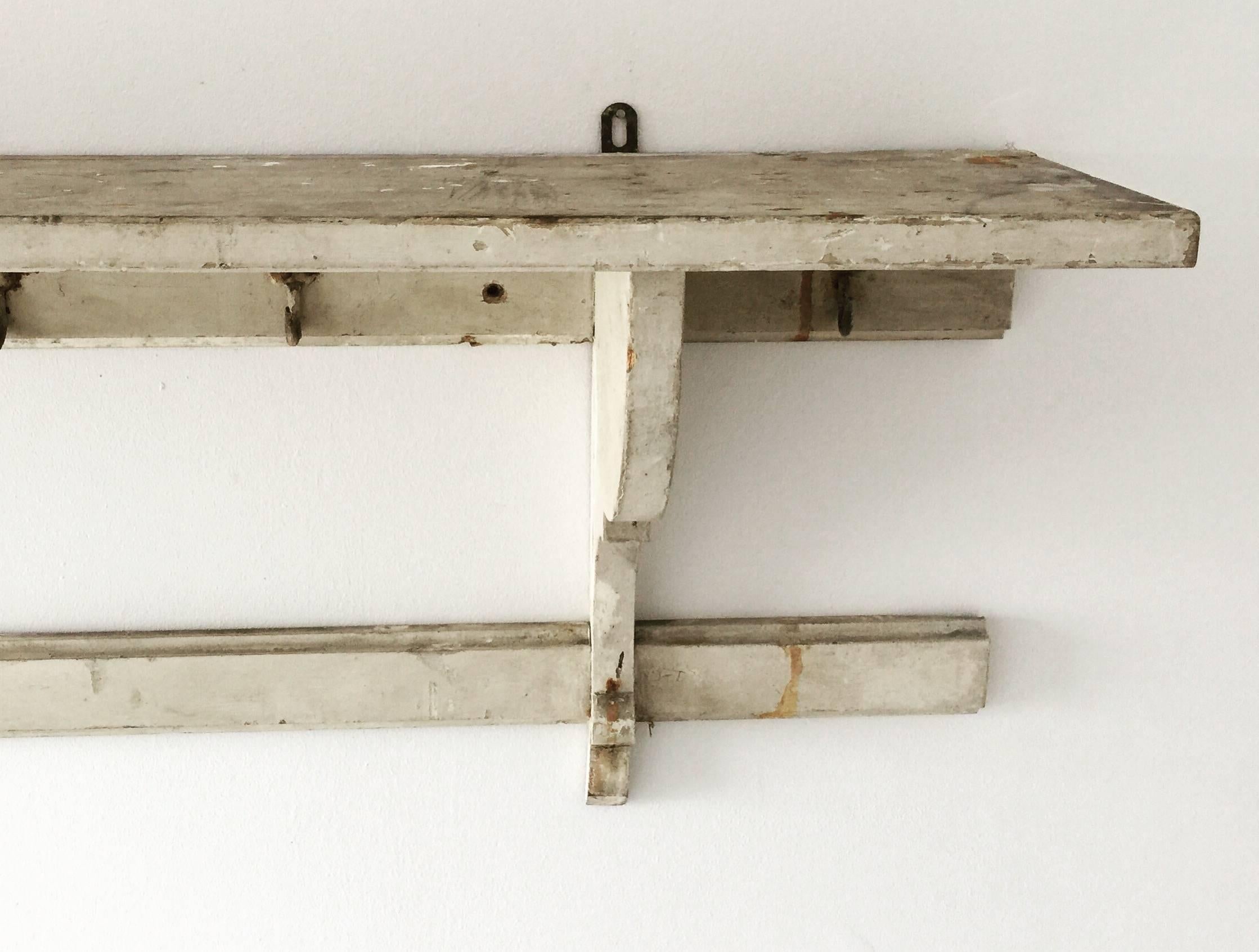 Large 19th century rustic French farmhouse game rack shelf with original paint and forged hooks.