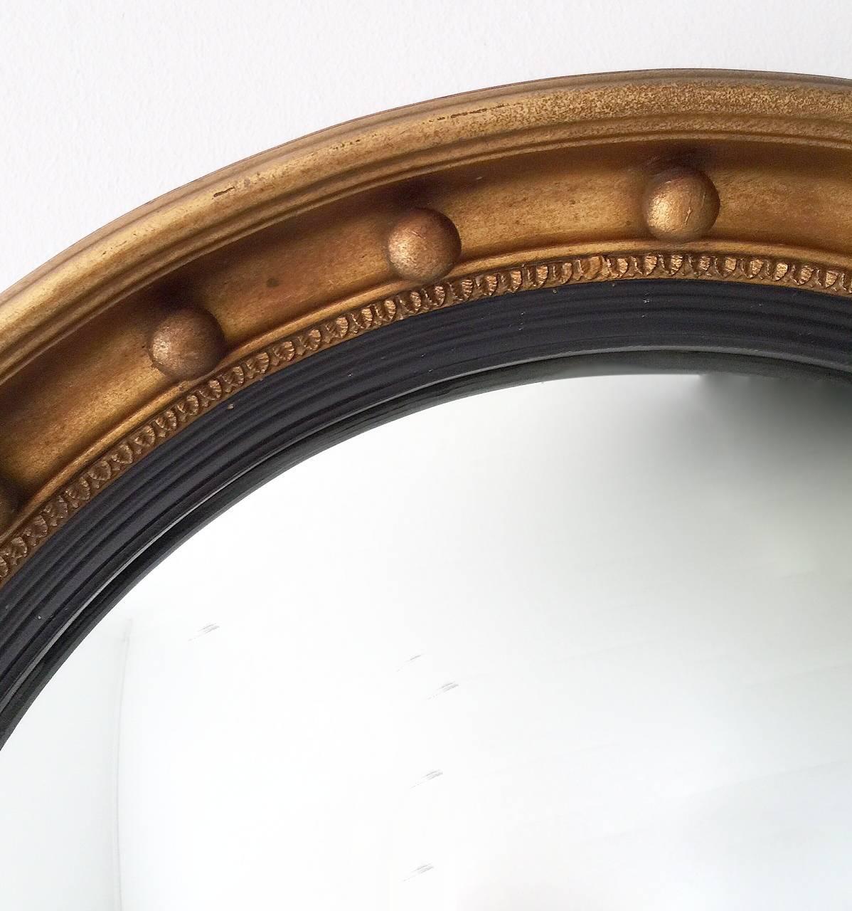 Very good condition Regency style mid-20th century convex mirror with original mirror plate.

