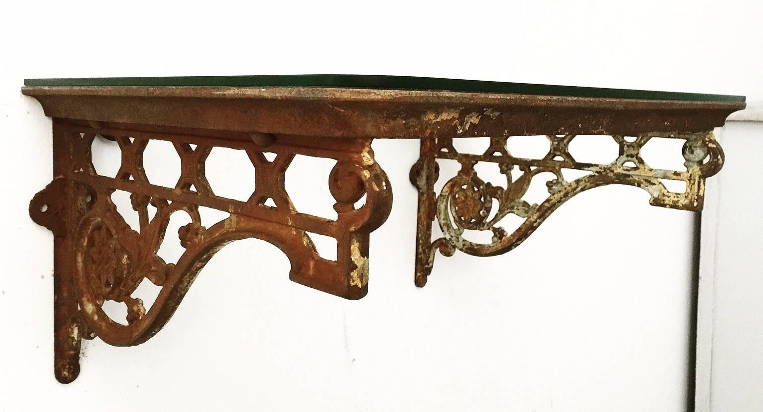 Victorian cast iron glass topped console wall-mountable table with the remains of original paint.