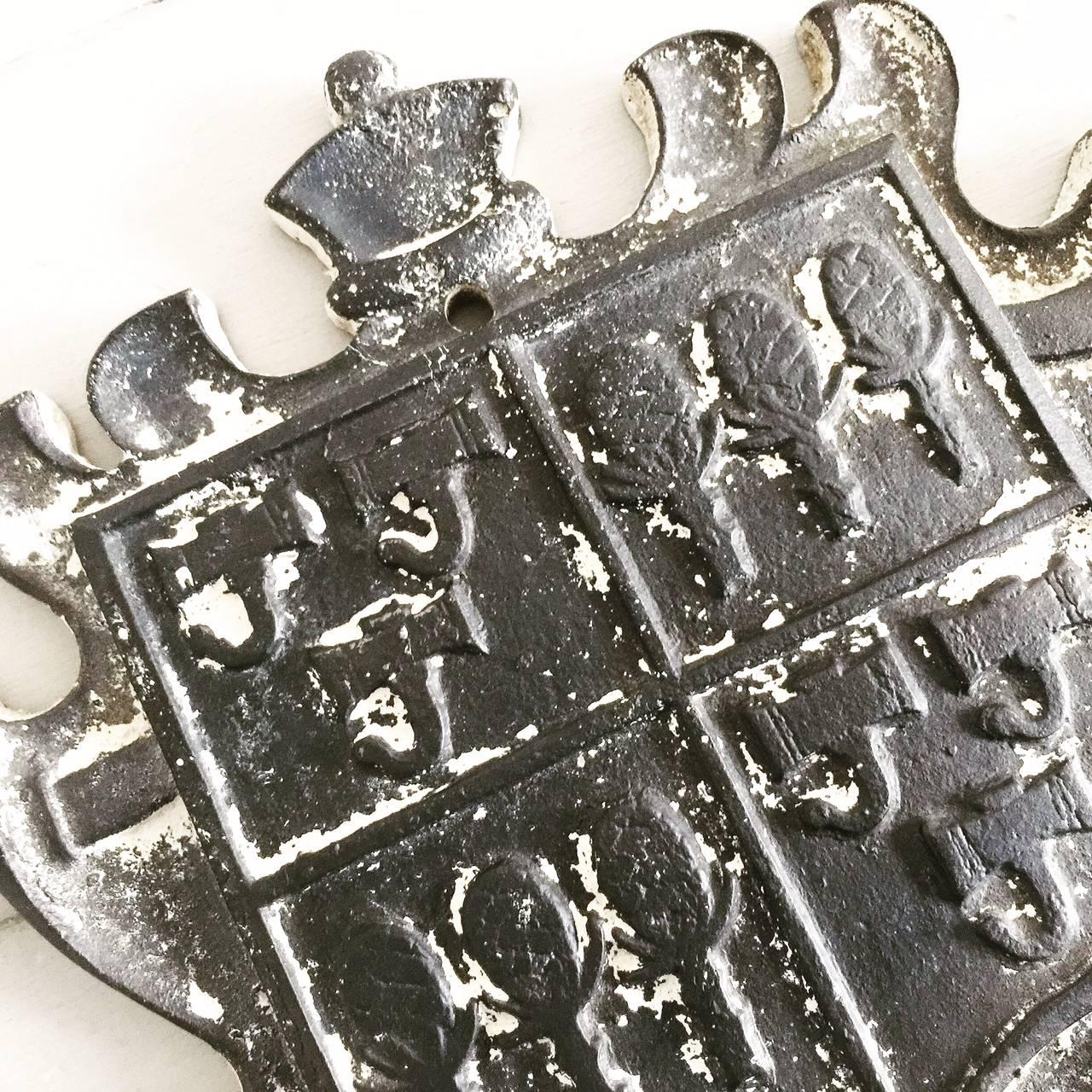 Vintage cast iron coat of arms shield.