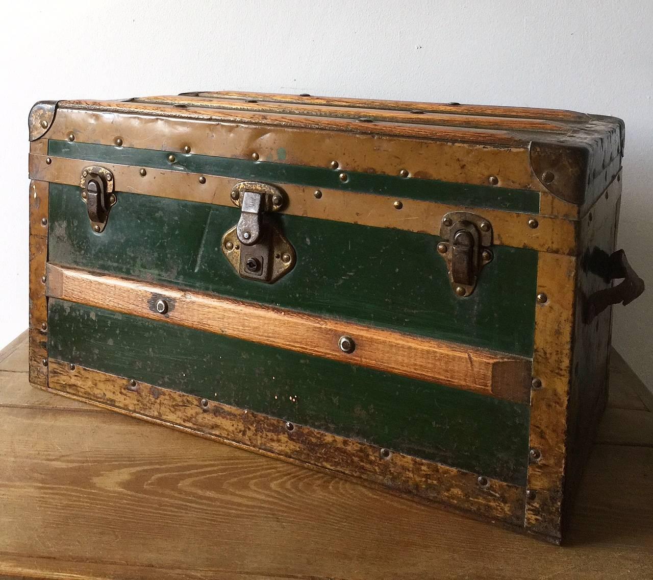 Fabulous antique miniature size traveling steamer trunk with hardwood strapping and a metal outer construction. Please note one of the leather handles is split but could easily be repaired.