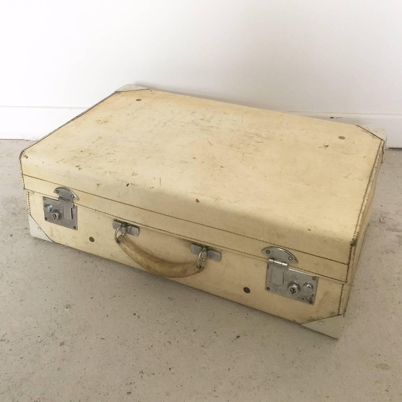 Vintage vellum suitcase with nickel-plated hardware.