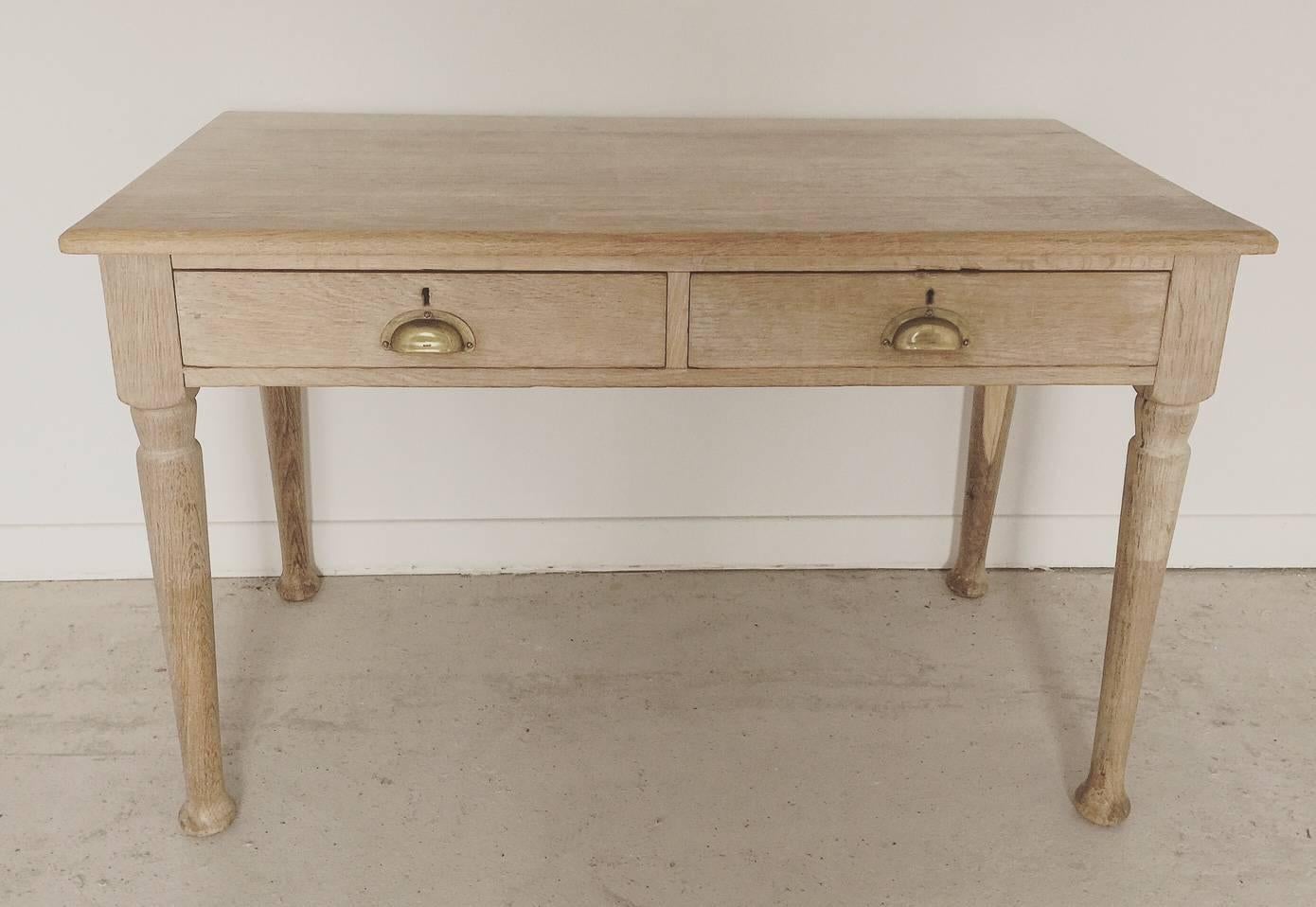 Antique Vintage English bleached oak desk table with two drawers and brass cuped handles.