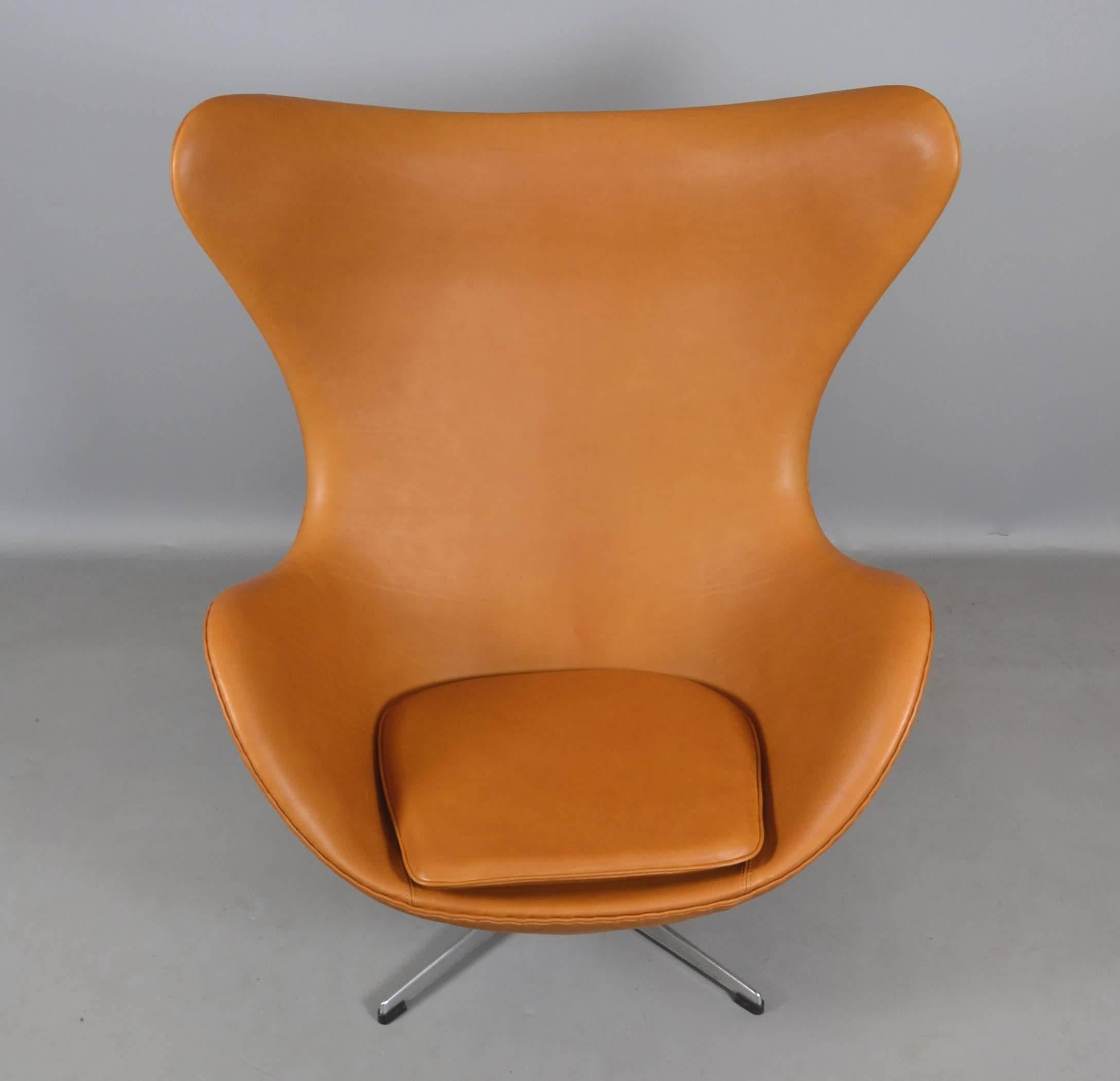 Designed by Arne Jacobsen in 1958, produced by Fritz Hansem, circa 1970. Original chair from the first production with brand new cognac aniline leather.