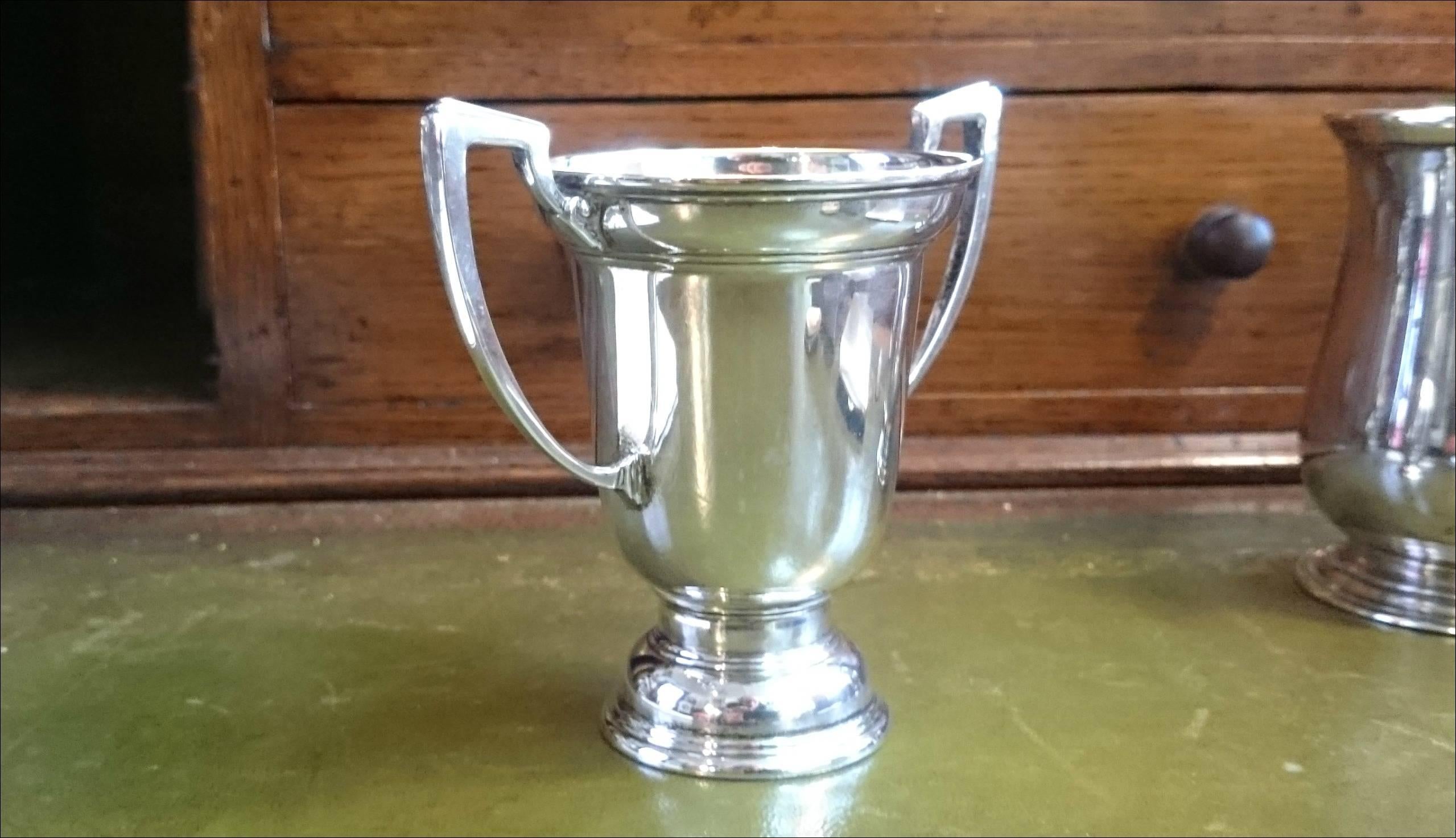 A sterling silver trophy jug made by Harrods, stamped 1932.
   