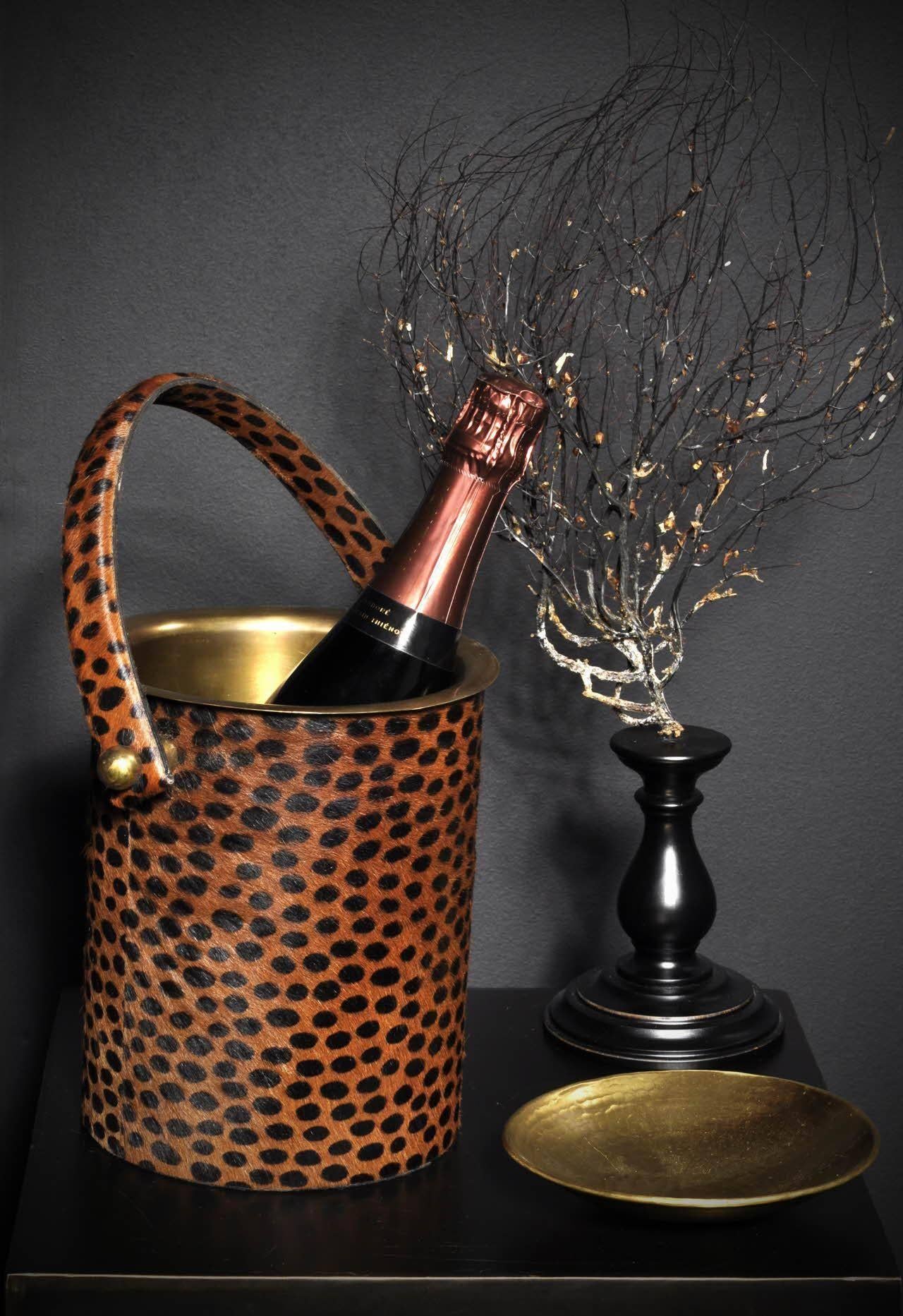 Wine cooler in fake fur leopard pattern and brass. Balanced and solid, comes from Paris and is inspired by the years ' 20s-40s, both in terms of design and to the use of animal pattern.