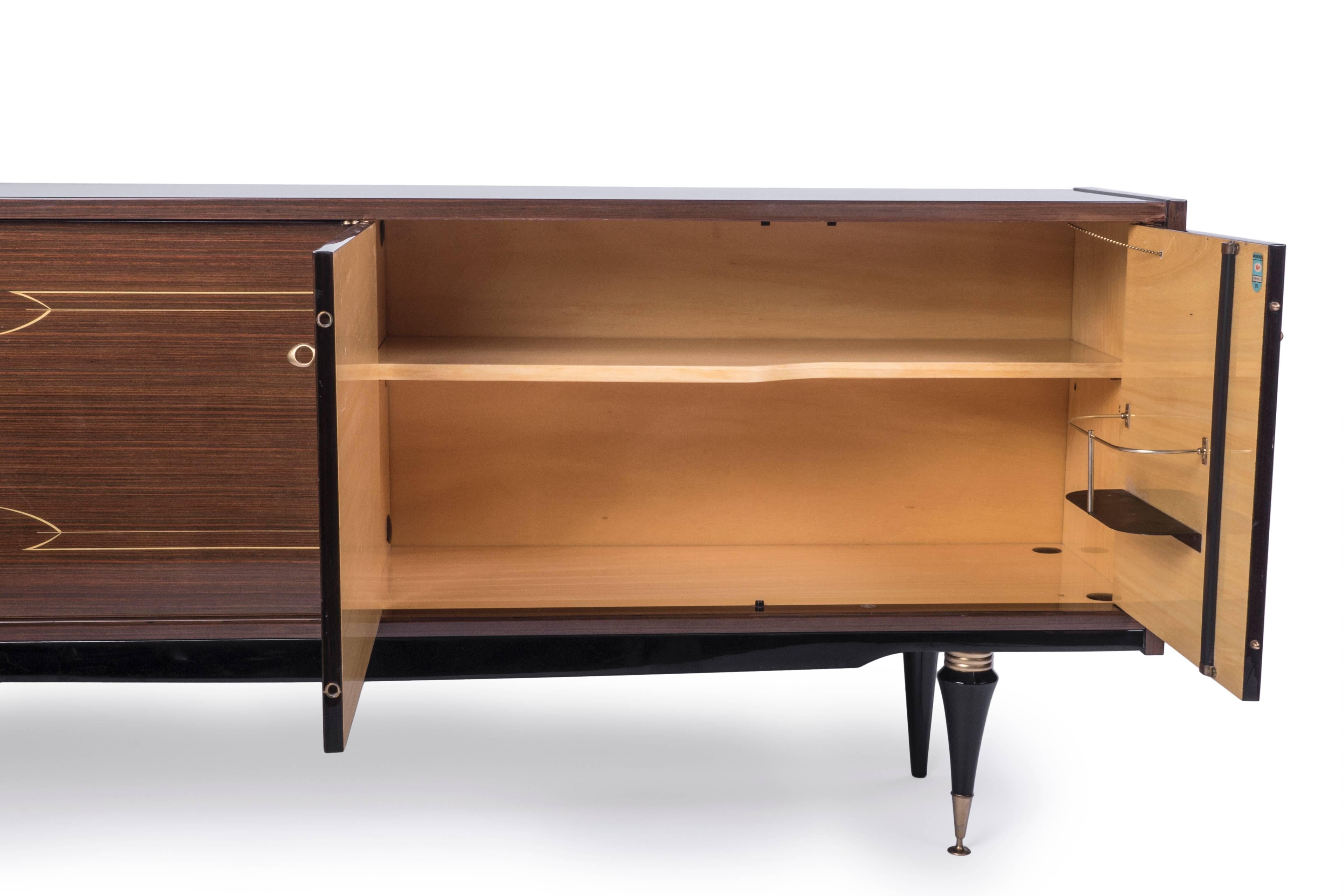 Luxe French Art Deco Macassar ebony buffet with mother of pearl and ivory inlay decorations.

Made in France, circa 1935.