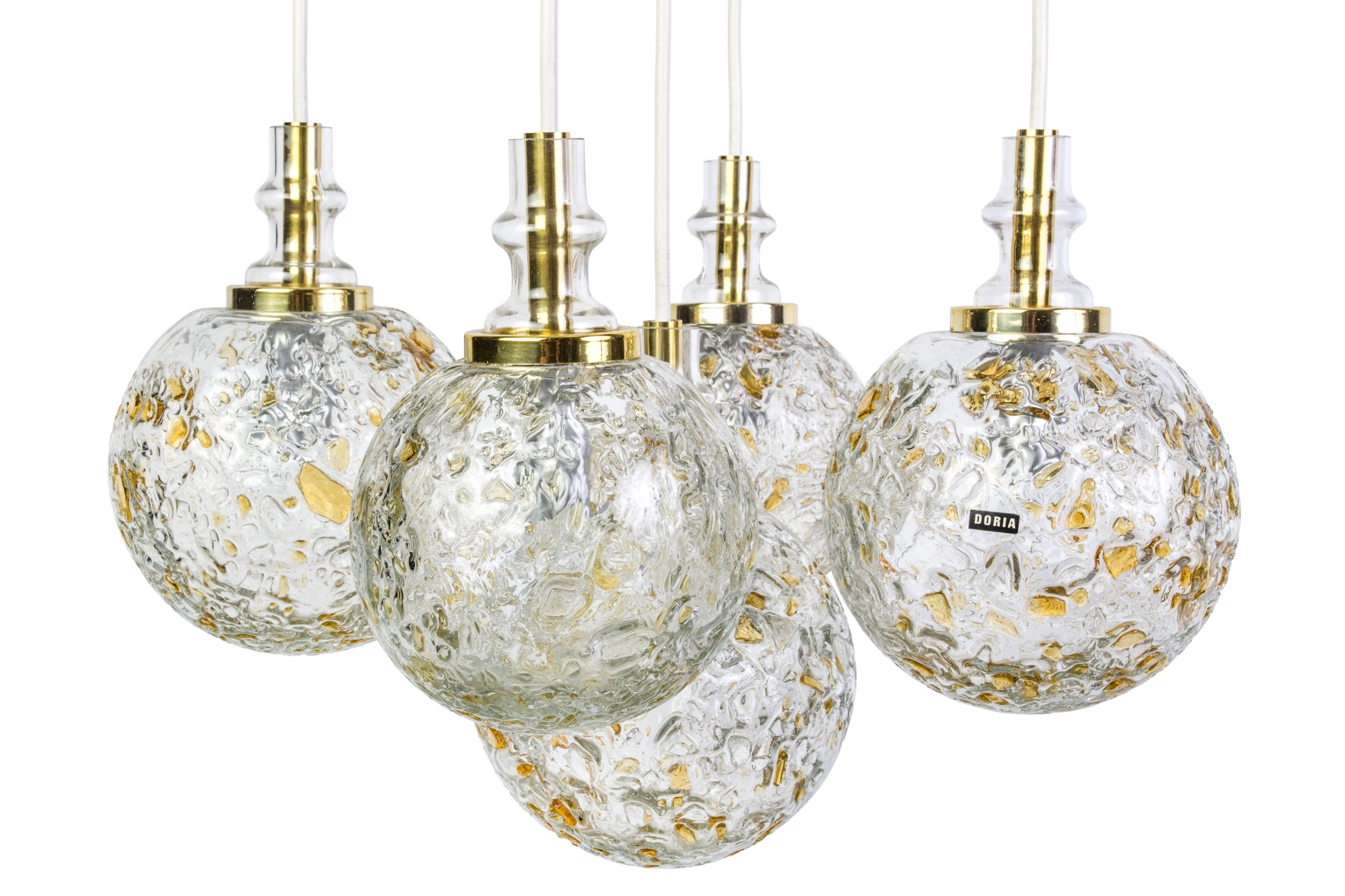This superb ceiling pendant by Doria features five cascading Murano glass balls in excellent original condition. The beautiful corrugated blown glass shades provide the perfect filtered light and disguise for the bulbs.

Measures: Diameter glass