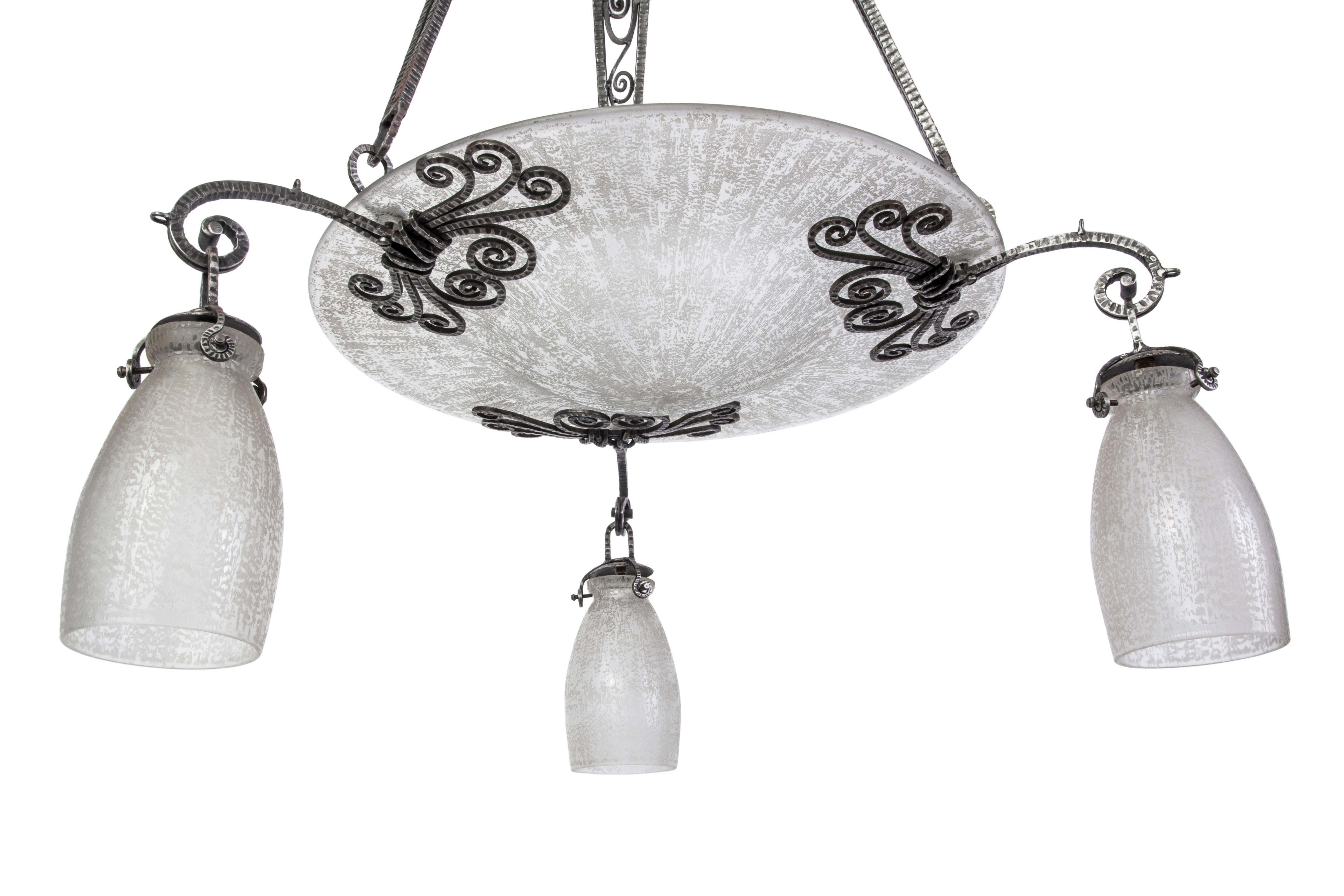 This stunning French Art Deco chandelier is made out of silvered wrought iron attributed to Edgar Brandt with acid-etched glass shades signed Daum-Nancy. 

Made in France, circa 1920.

  
