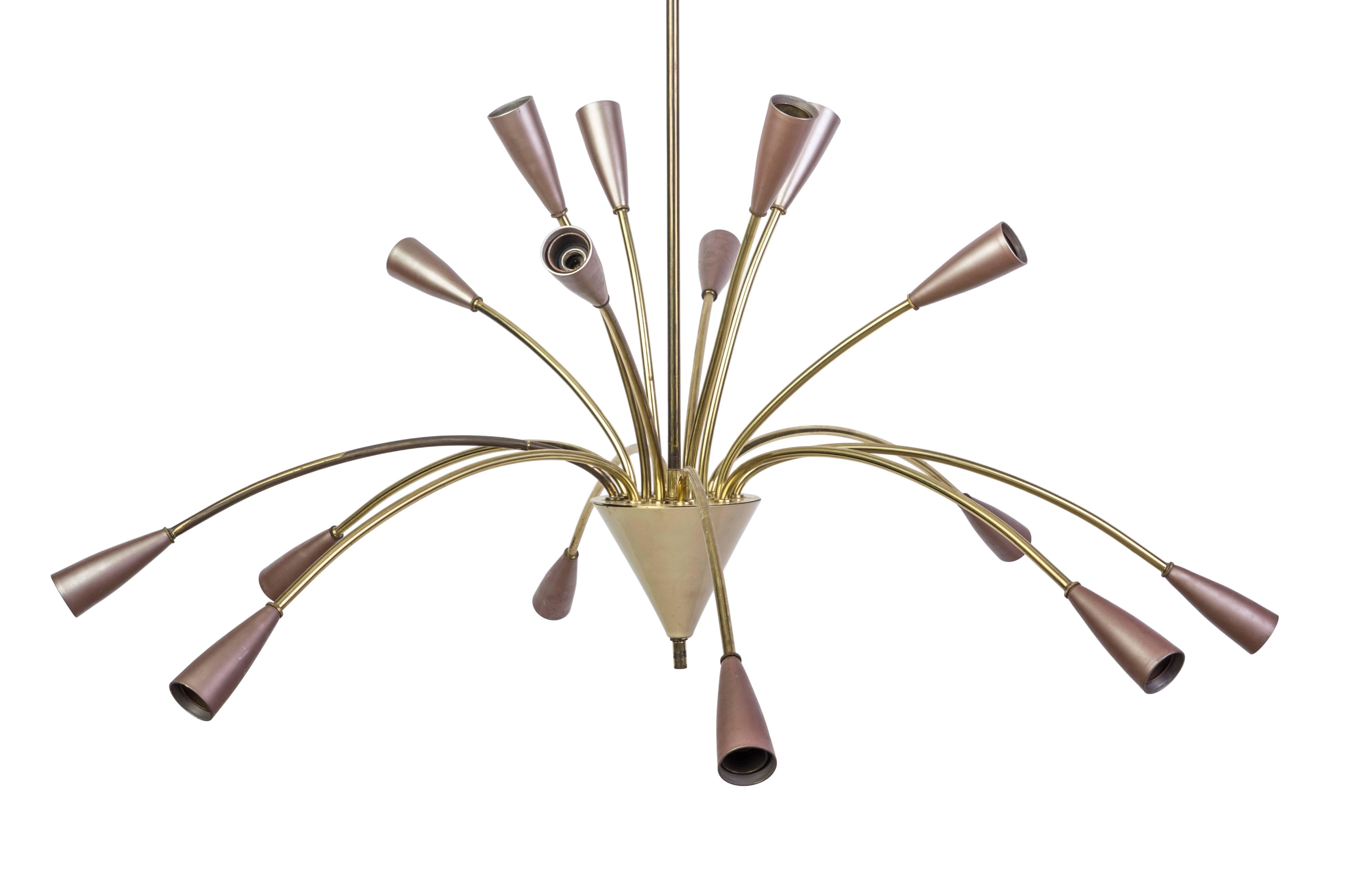 This spectacular 1950's 16-arm Sputnik spider chandelier is reminiscent of an explosive firework with its brass frame and arms extending out to conical form lights with pearlized mauve enameled shades.  The chandelier is in excellent, original