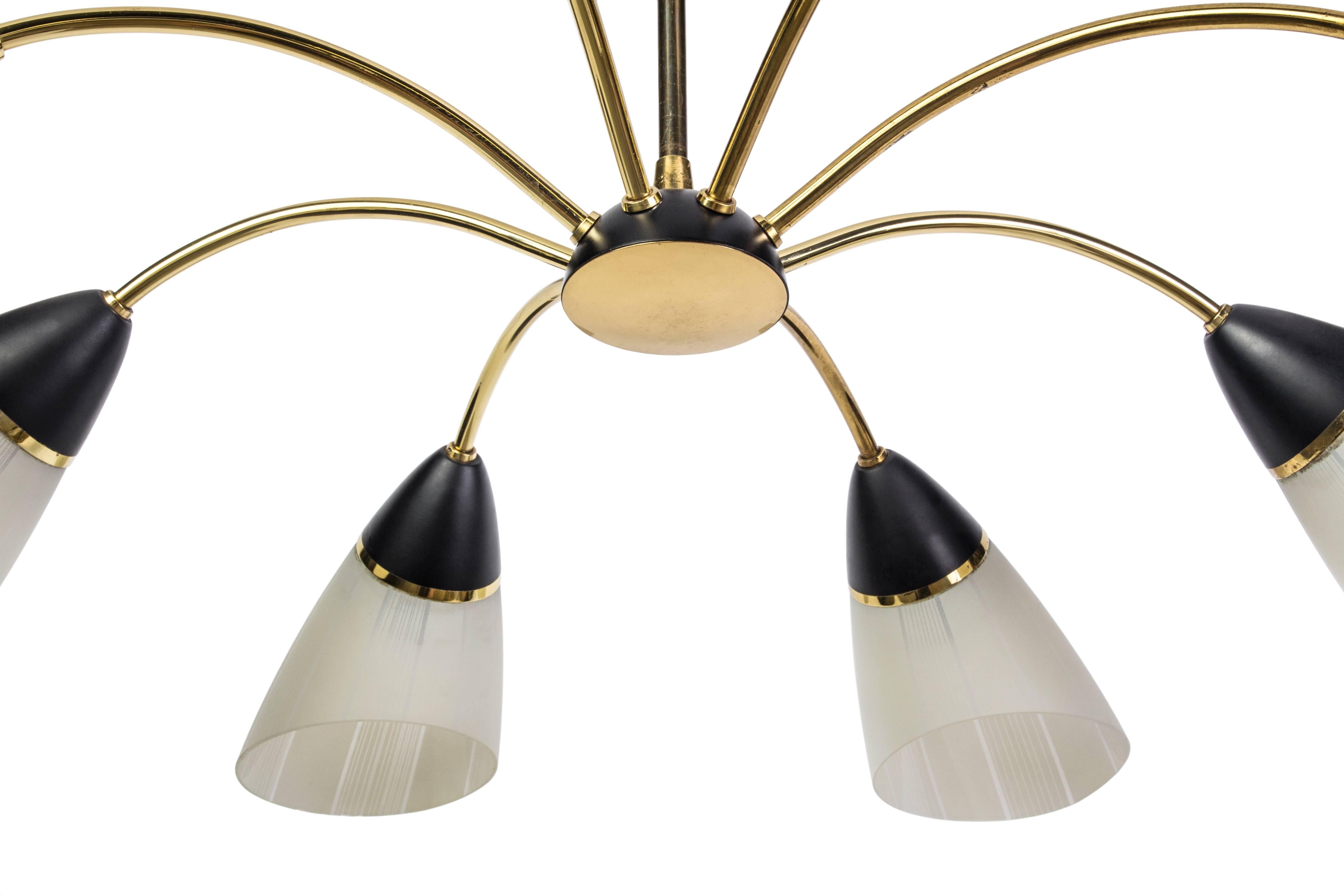 This beautiful Mid-Century Modernist chandelier features a spider form design brass frame and black details with eight conical glass shades.

Made in Germany, circa 1950.
