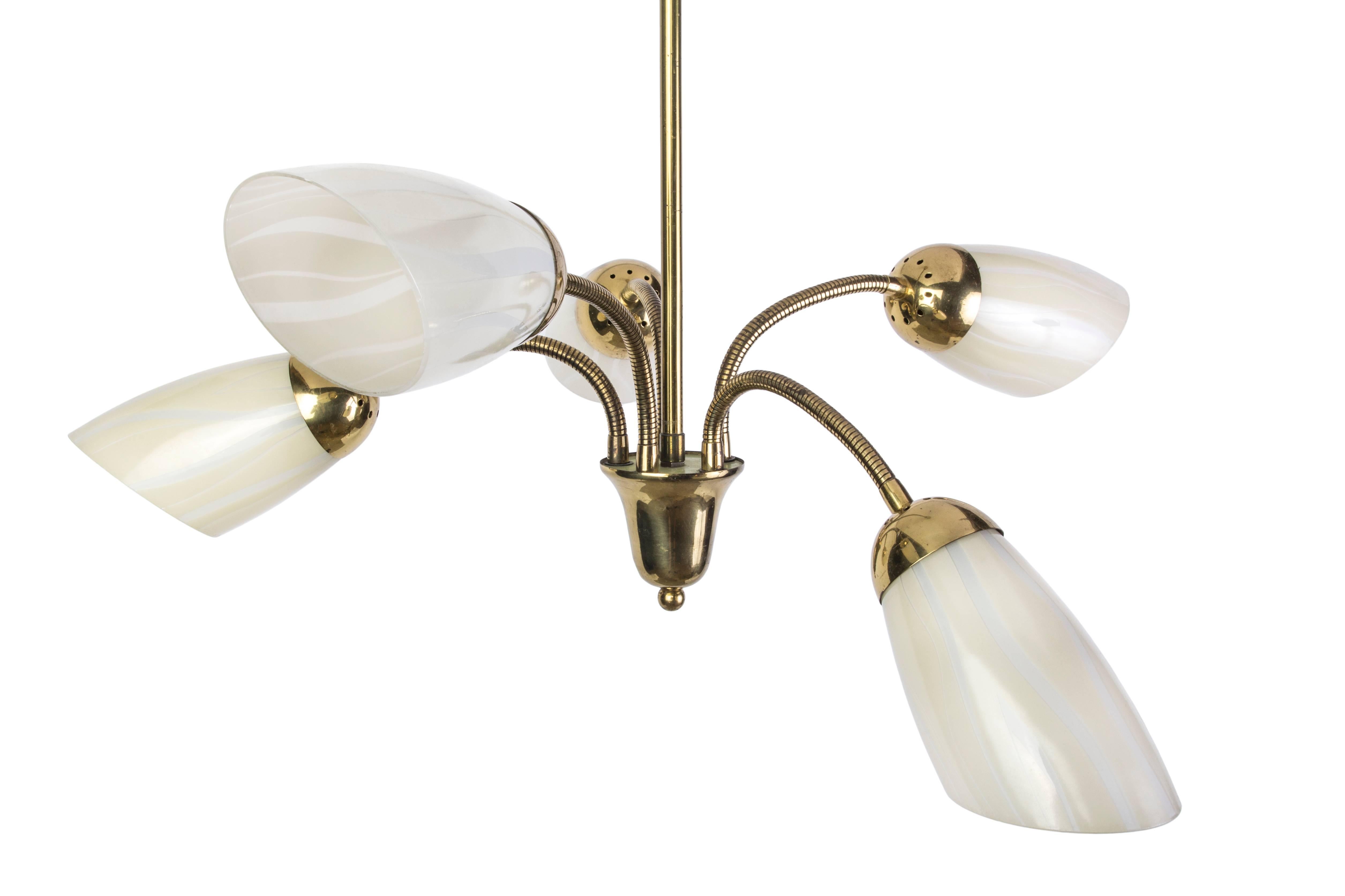 This chic Mid-Century Modernist chandelier features a spider form design brass frame and black details with five conical glass shades and adjustable multi-directional arms.

Made in Germany, circa 1950.
