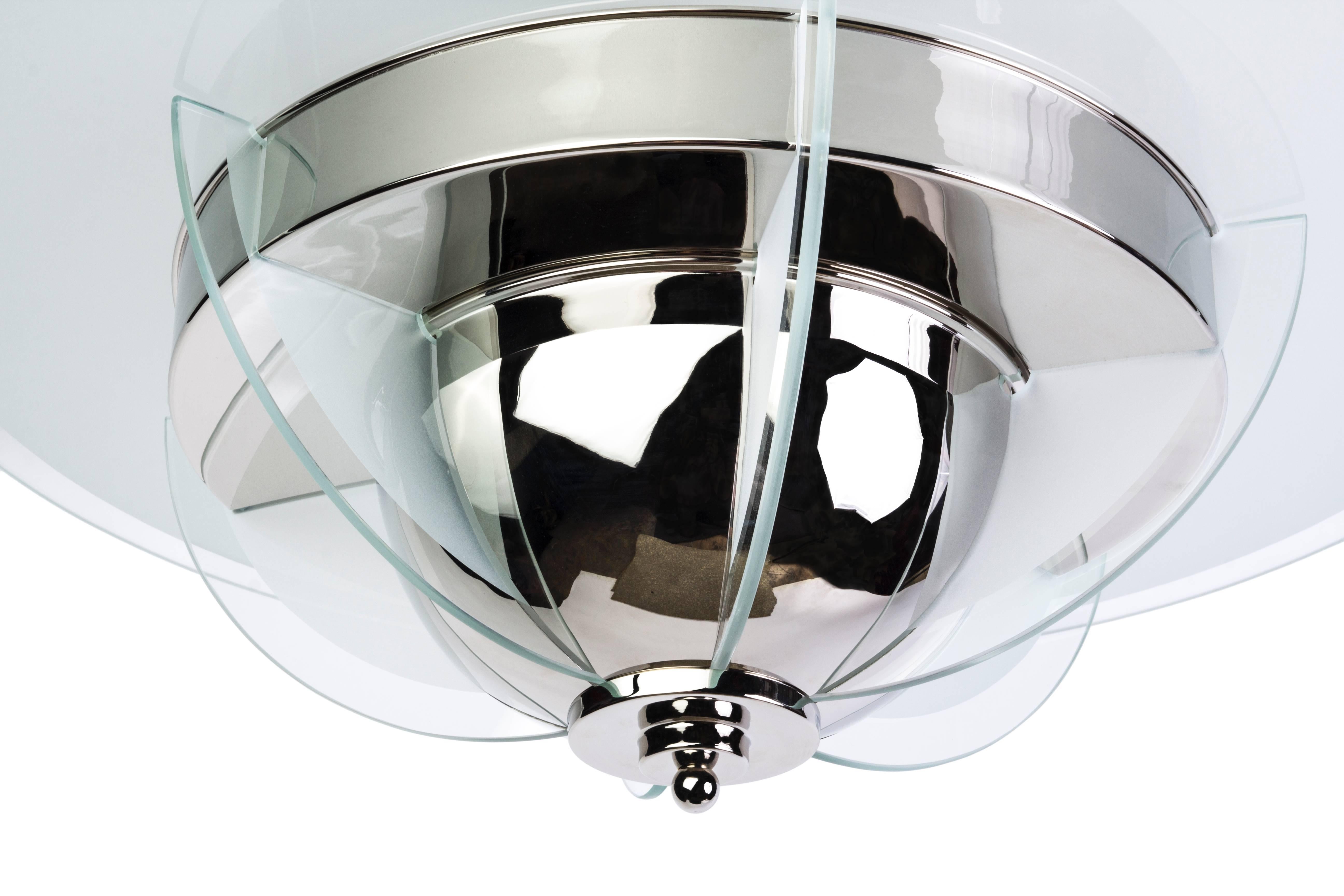 This elegant Art Deco style chandelier or pendant features a circular frosted glass form with chrome frame and frosted glass inserts.