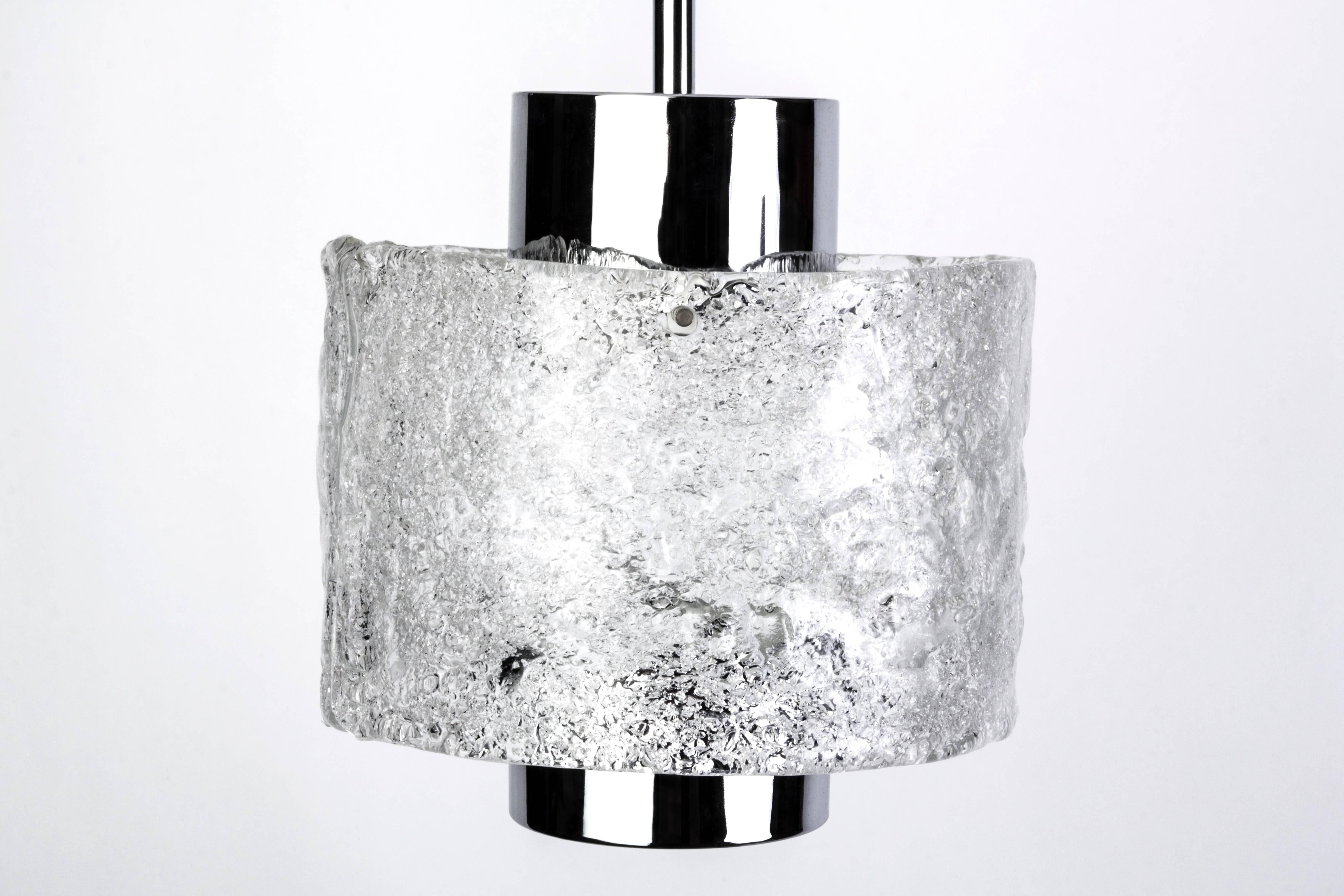 This gorgeous Mid-Century Modernist pendant was designed by Doria and it features a chrome frame with a cylindrical textured glass globe. It is in excellent condition and has been newly rewired.