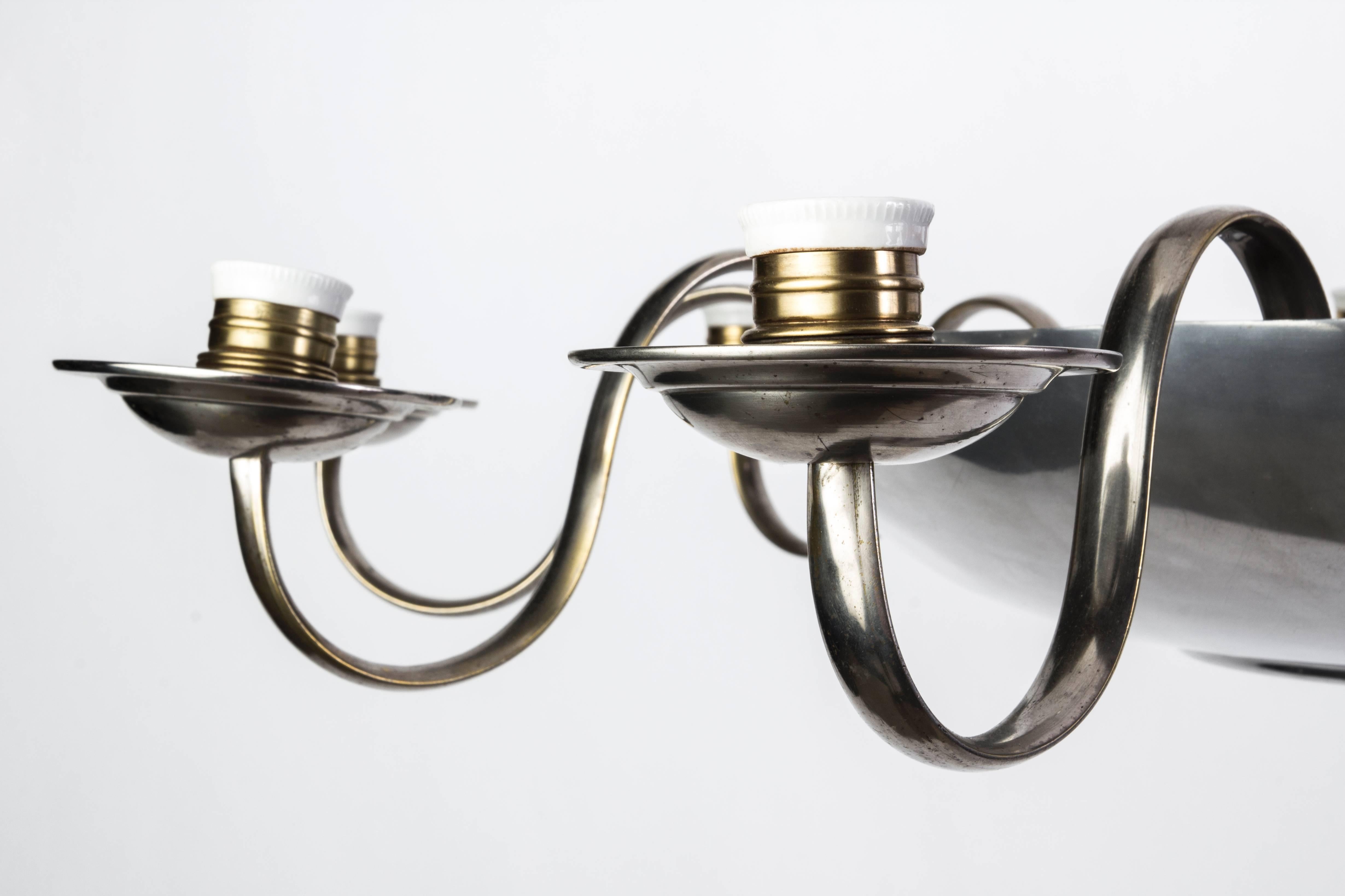 This wonderful Art Deco chandelier was designed by Bauhaus. It features a circular form design with an aluminum frame in antique nickel with (10) lights.

Made in Germany circa 1930.