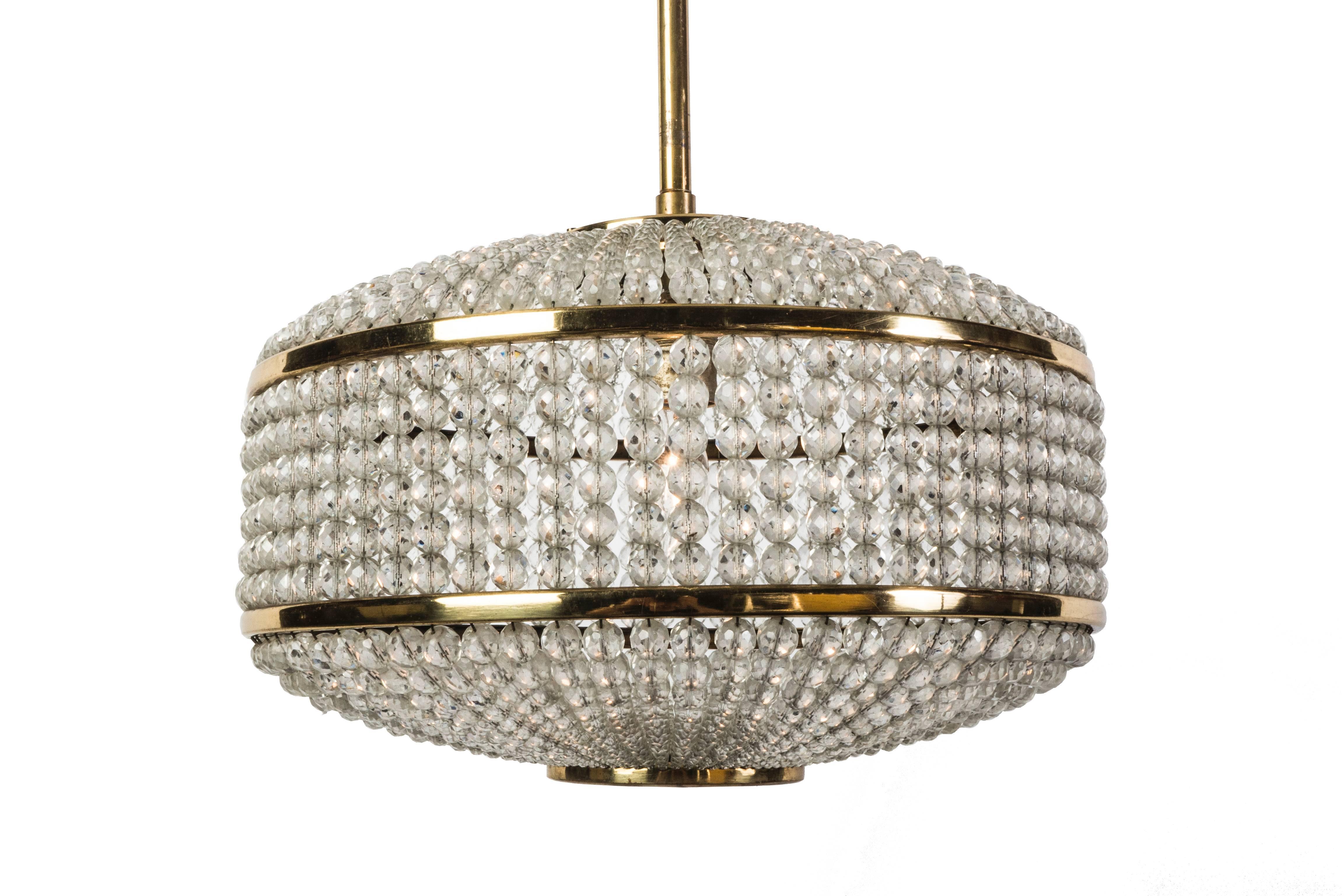 This exceptional pendant was designed by Lobmeyr. It features (2,500) Swarovski pearl crystals surrounding a circular brass base. It is in excellent condition and has been newly rewired.

 