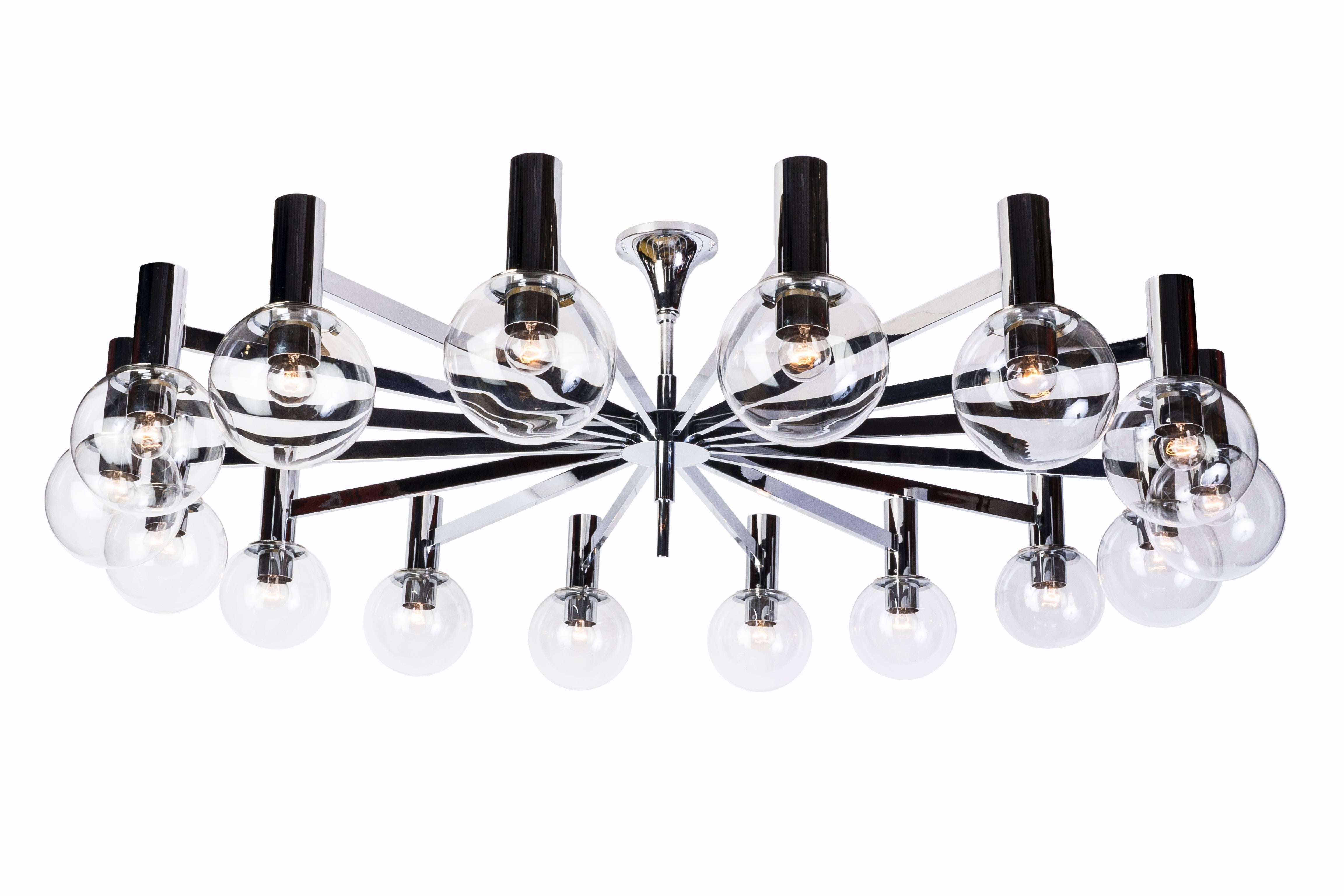 This stunning (16) light Sputnik chandelier by Hans-Agne Jakobsson features a beautiful streamline chrome frame and fine clear glass globes. The chandelier is in excellent, original condition and has been newly rewired.
