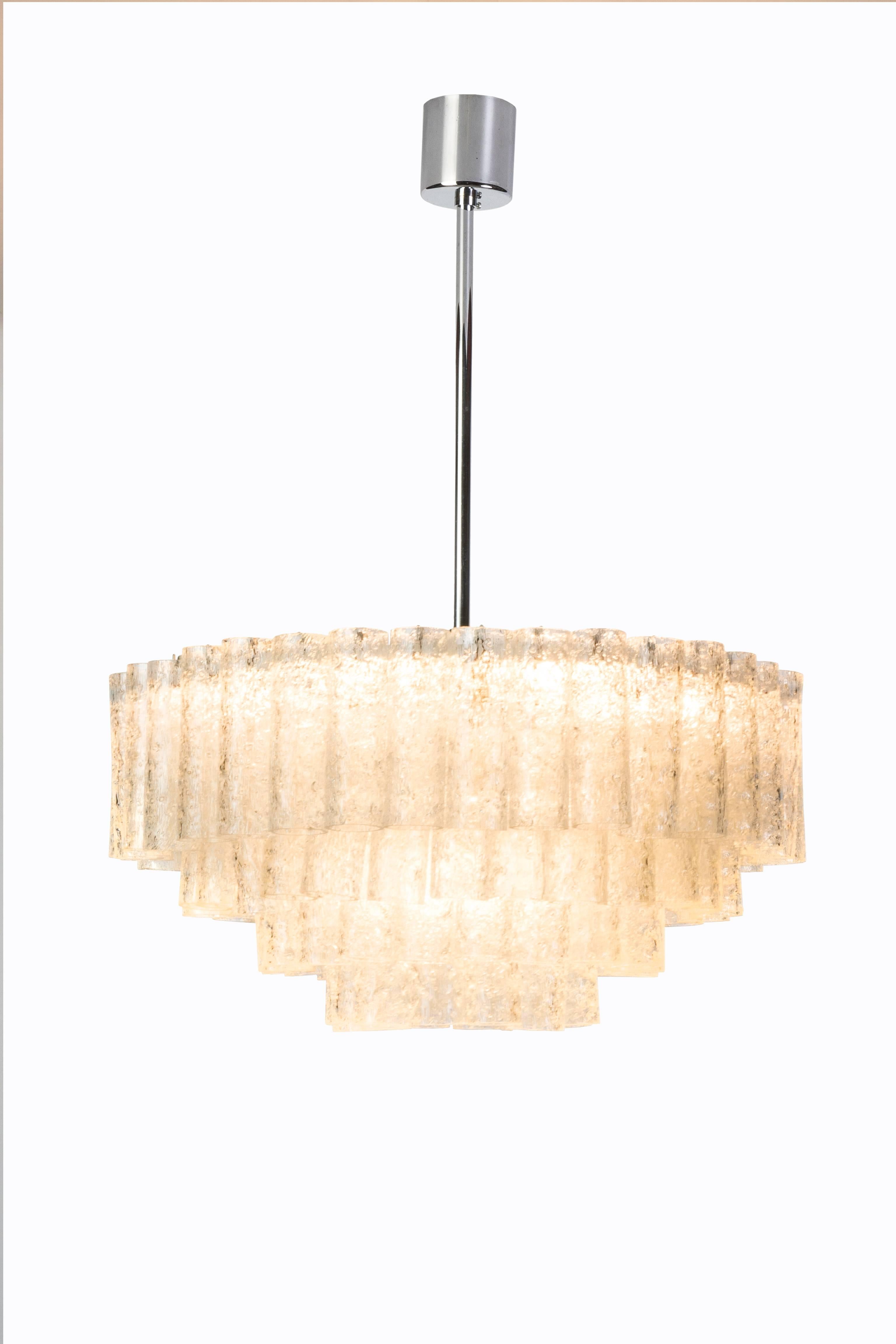 This exceptional German Art Deco chandelier was created by Doria. It features multi-tiered texture glass tubes cascading from a chrome base giving it an icicle form design.