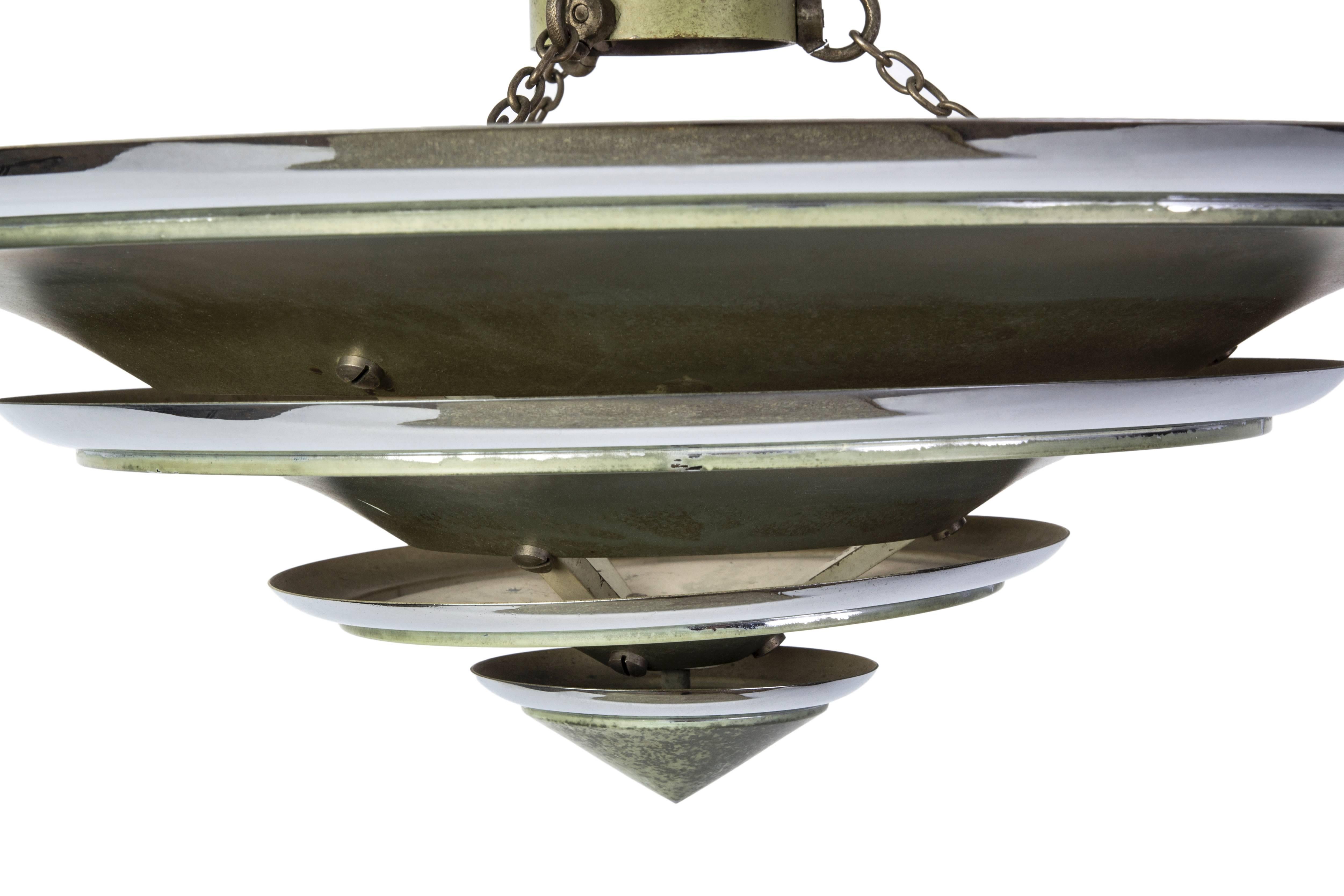 This Classic Bauhaus pendant features a cone shape shade with original patina and chrome trims.

Made in Germany, circa 1950.