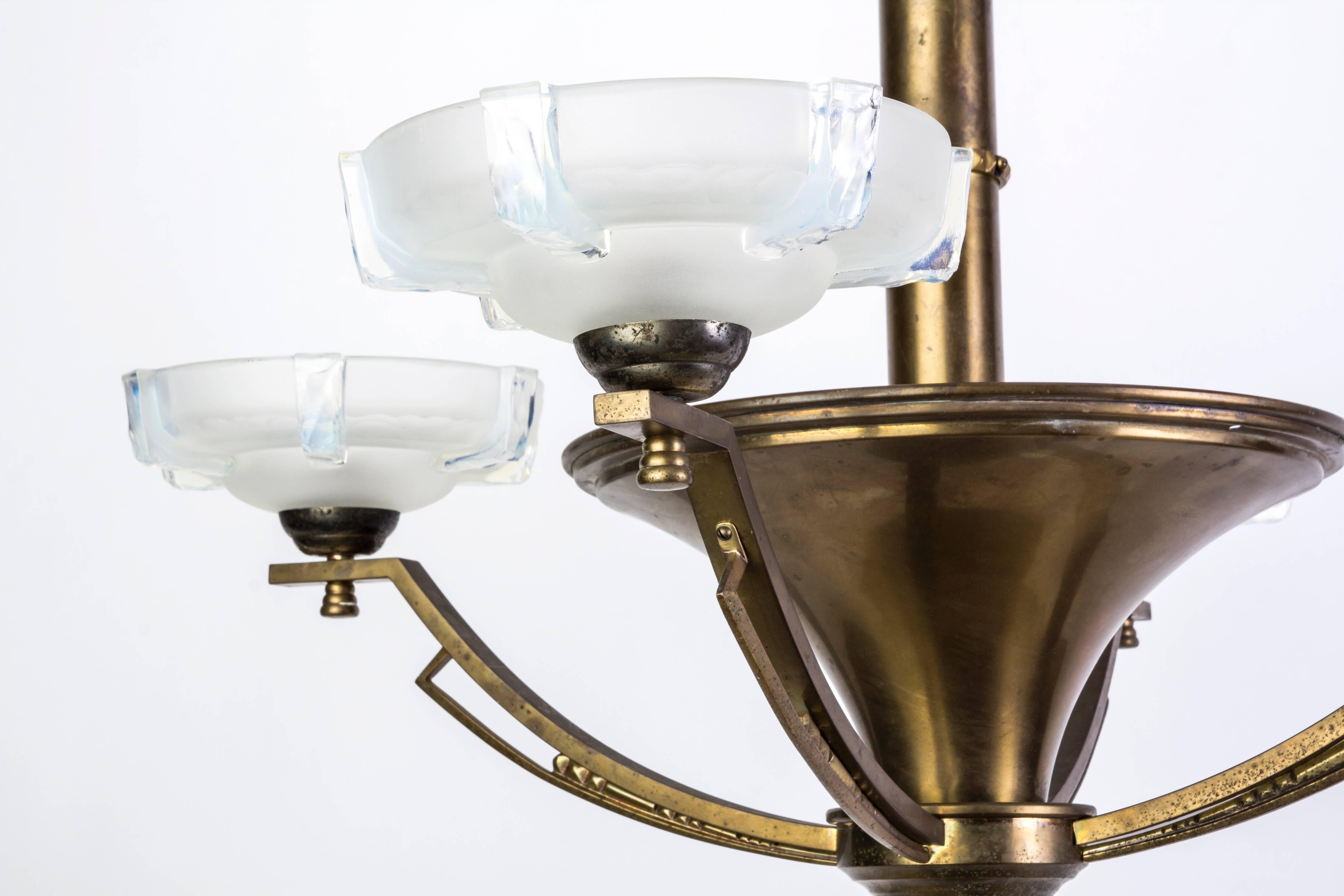 This unusual French Art Deco chandelier features a brass frame and four (4) opalescent glass shades. The frame has a cone-shape design. This is a transitional piece Nouveau - deco.

Made in France, circa 1920

Measures: 32