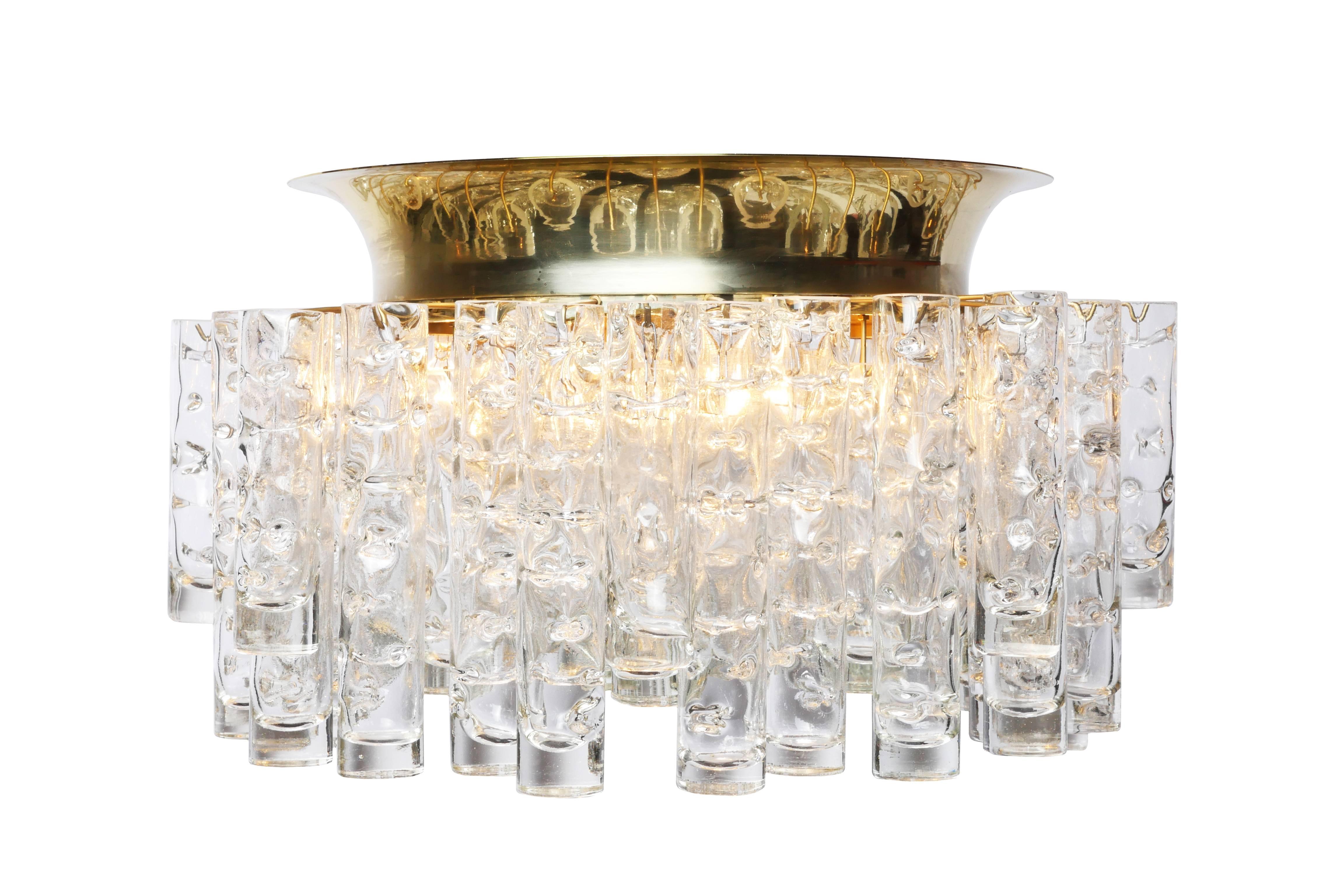 This exceptional German 1950s flush mount was designed by Doria. It features 48 handblown textured glass tubes cascading from a circular brass frame. It is in excellent condition and has been newly rewired.