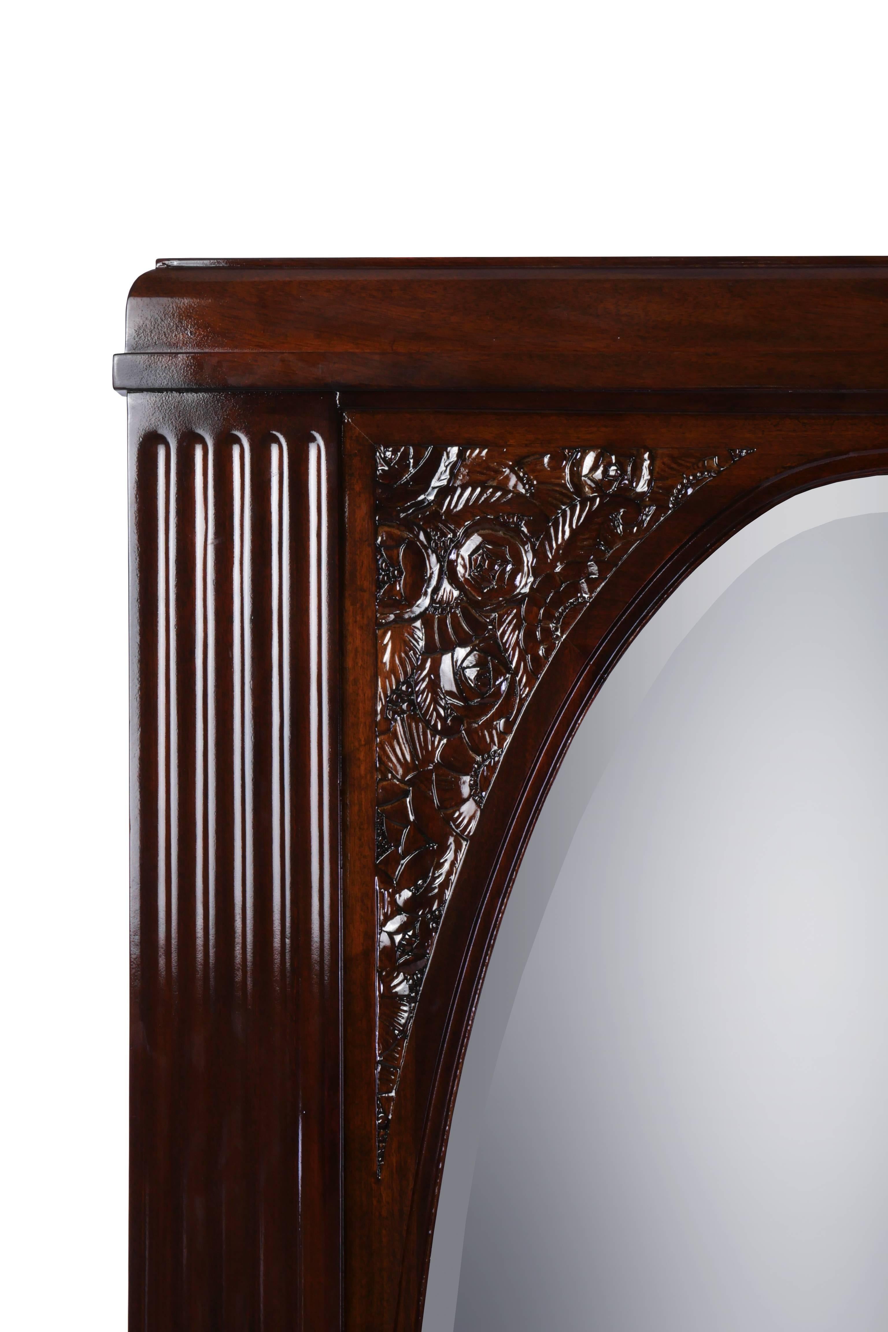 Impressive rectangular solid mahogany Art Deco freestanding mirror with carved floral decoration and oval mirror insert.