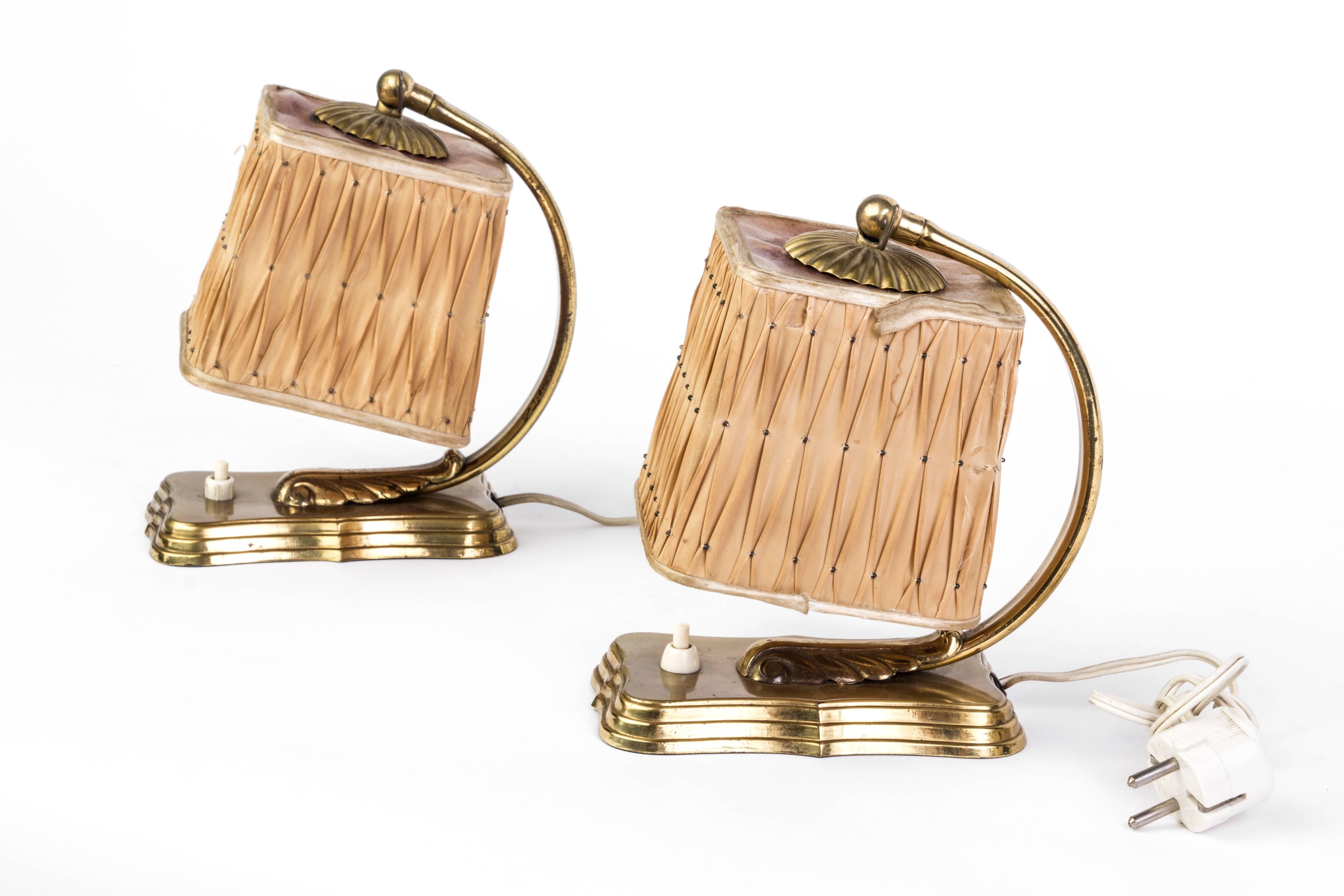 This gorgeous pair of silk and brass Art Deco bedside Lamps captures the boudoir style of Hollywood Regency with their soft, rose-colored silk shades and beautifully gilded brass frames. 

Made in America, circa 1940.

 
