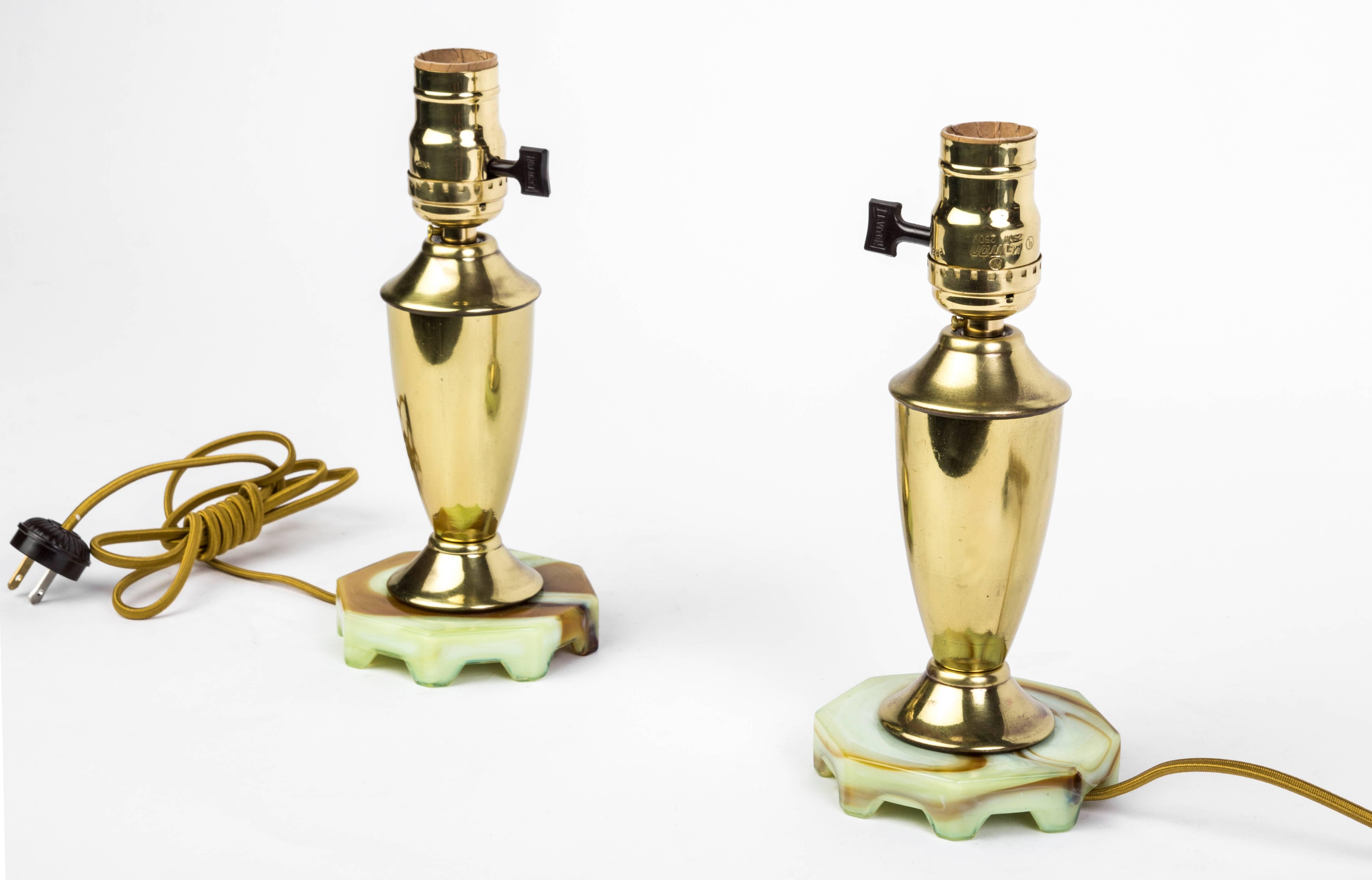 This beautiful pair of Art Deco up-lights feature a brass frame that sits atop a jadeite base. They are in excellent condition and have been newly rewired.

Made in France, circa 1930.

