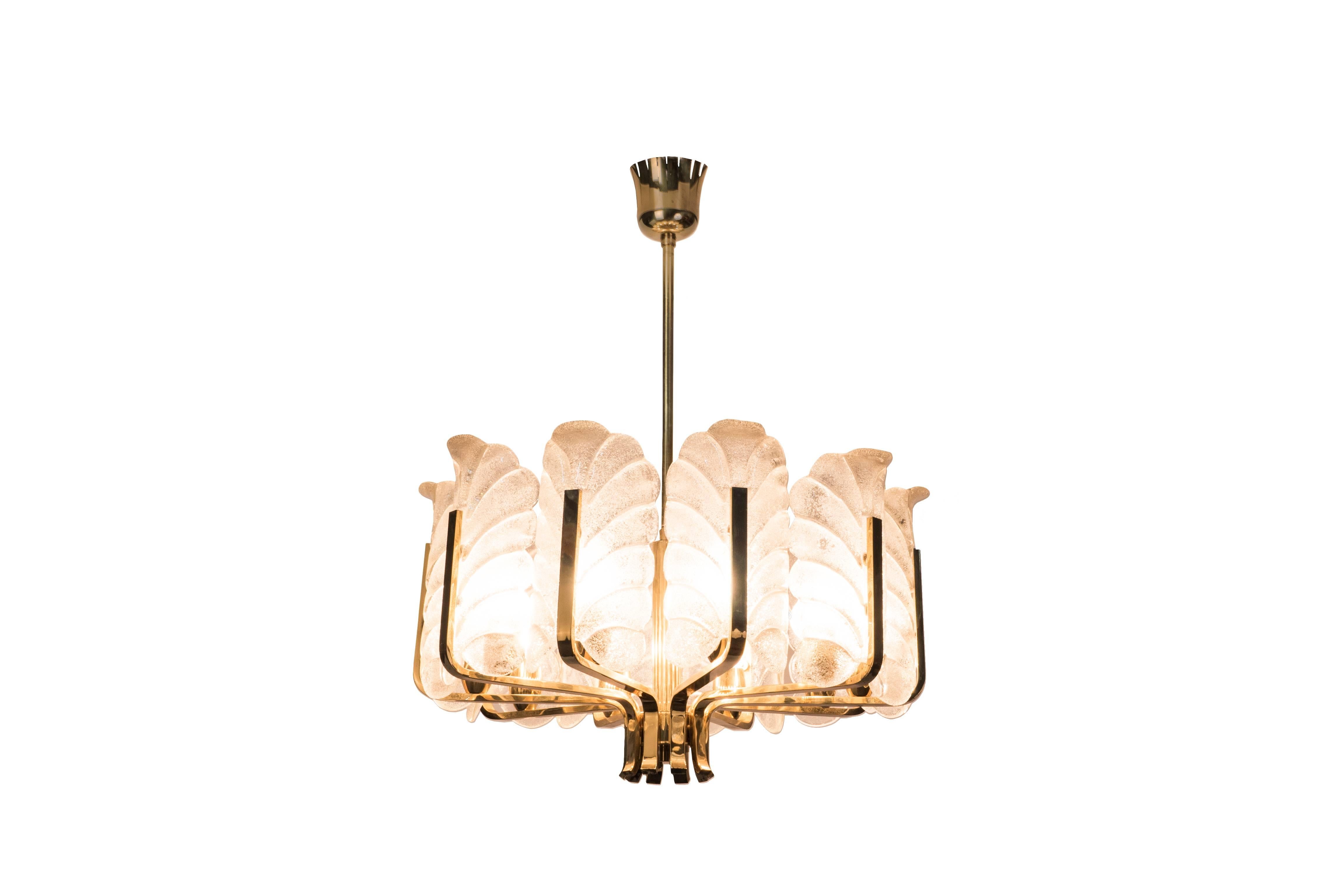 This exquisite Mid-Century Modernist chandelier was designed by Carl Fagerlund and it features a ten-arms frame in brass with iridescent glass stylized leafs by Orrefors.

Made in Sweden, circa 1940

Measures: 21 1/2