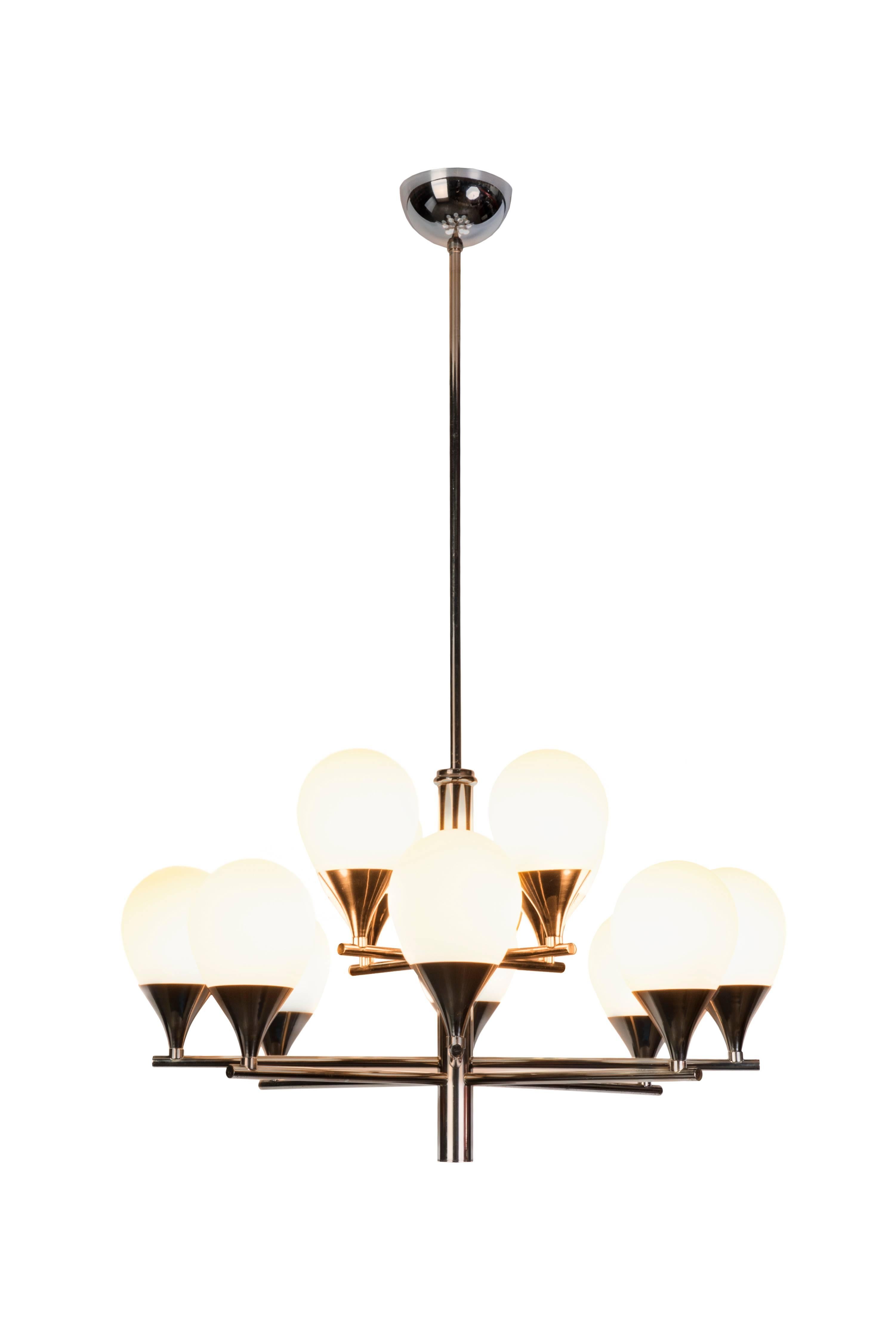 This gorgeous Mid-Century Modern chandelier features chromed brass frame that holds 12 double-layer opal glass shades distributed in two levels. Very straight light and simplistic in design.

Made in Italy, circa 1970.

Two available
Measures: