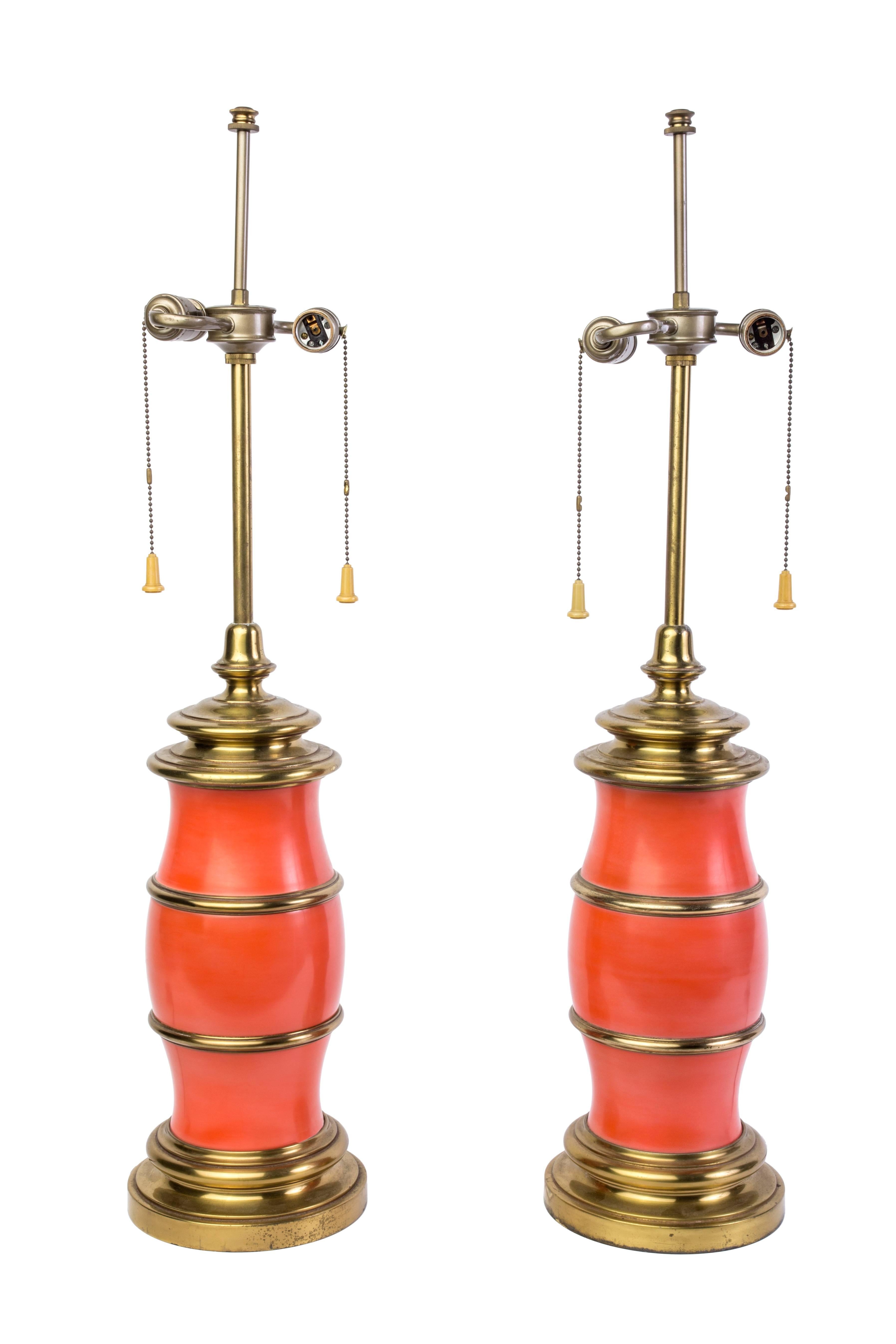 Pair of Mid-Century modernist lamps by Stiffel. They feature a ceramic centre in salmon color and brass frame. 

Made in America, circa 1960

Measures: 34 1/2