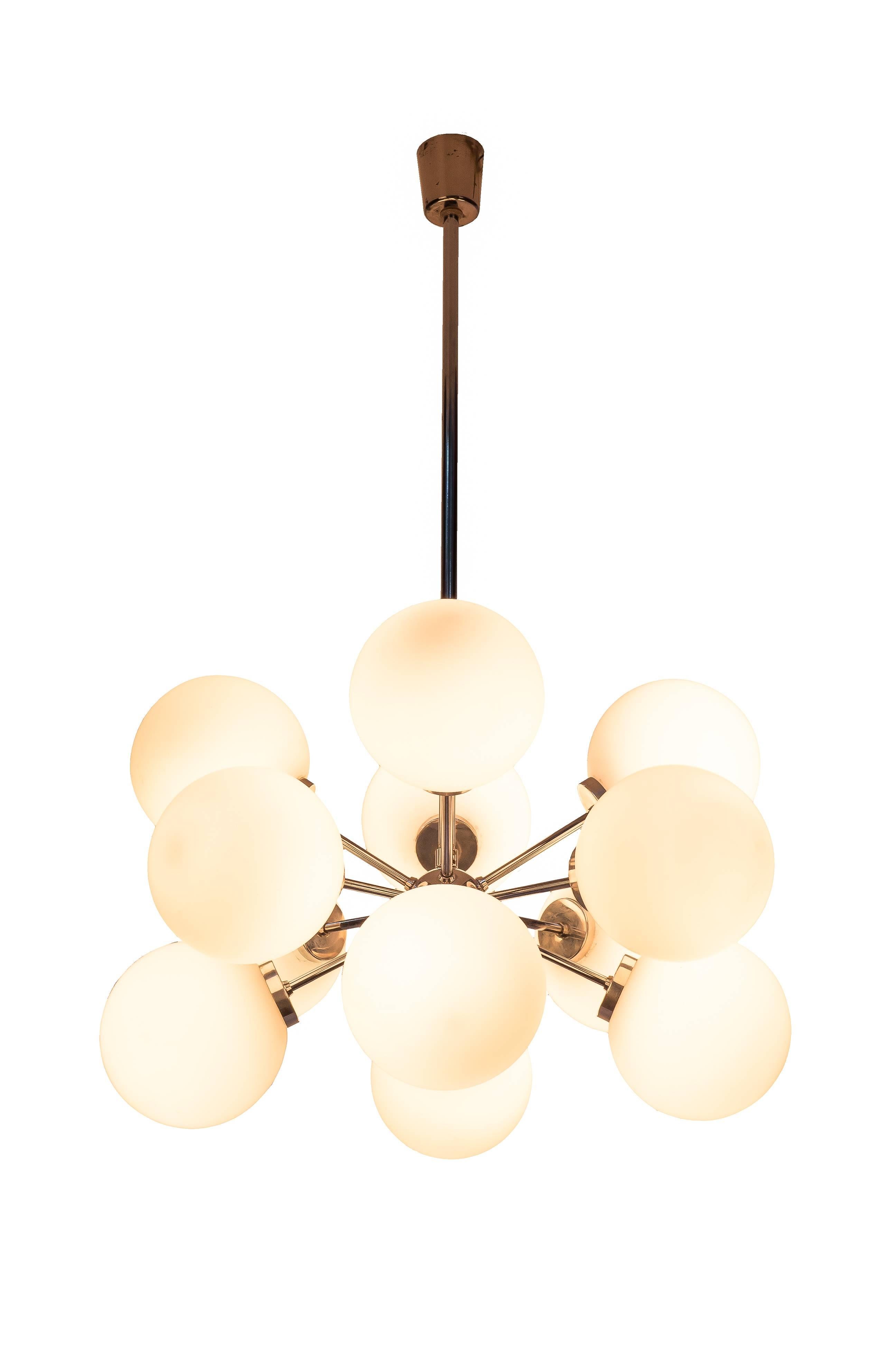 This gorgeous Mid-Century Modernist chandelier was designed by Richard Essig. It features a chrome base with twelve opal glass globes creating a cluster form design.

Made in Germany, circa 1965

Measures: 24