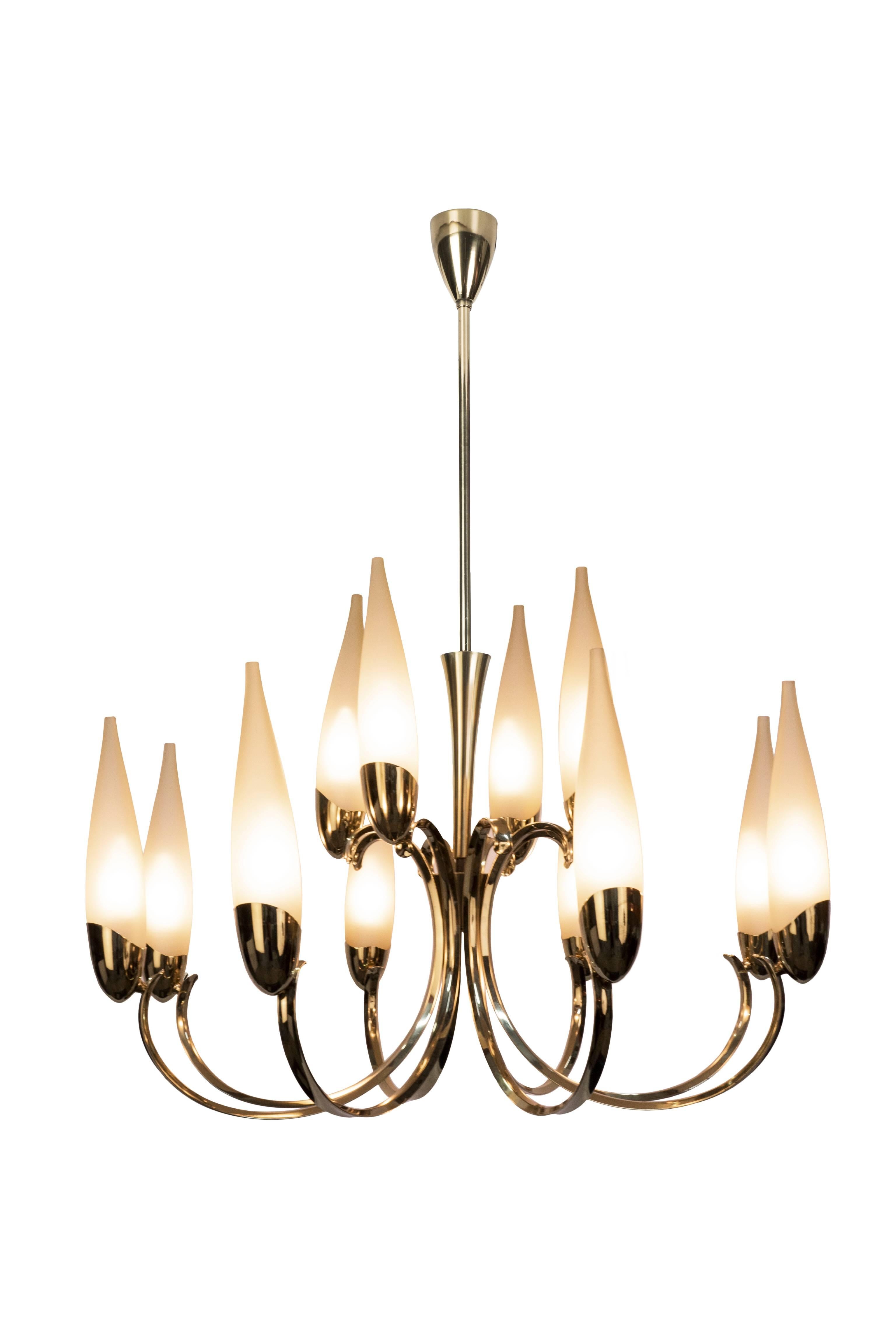 This wonderful 1950s Italian chandeliers in the manner of Stilnovo features a candelabra inspired design with a brass frame and (12) filigree handblown conical form lampshades.

Made in Italy, circa 1950

two available.
