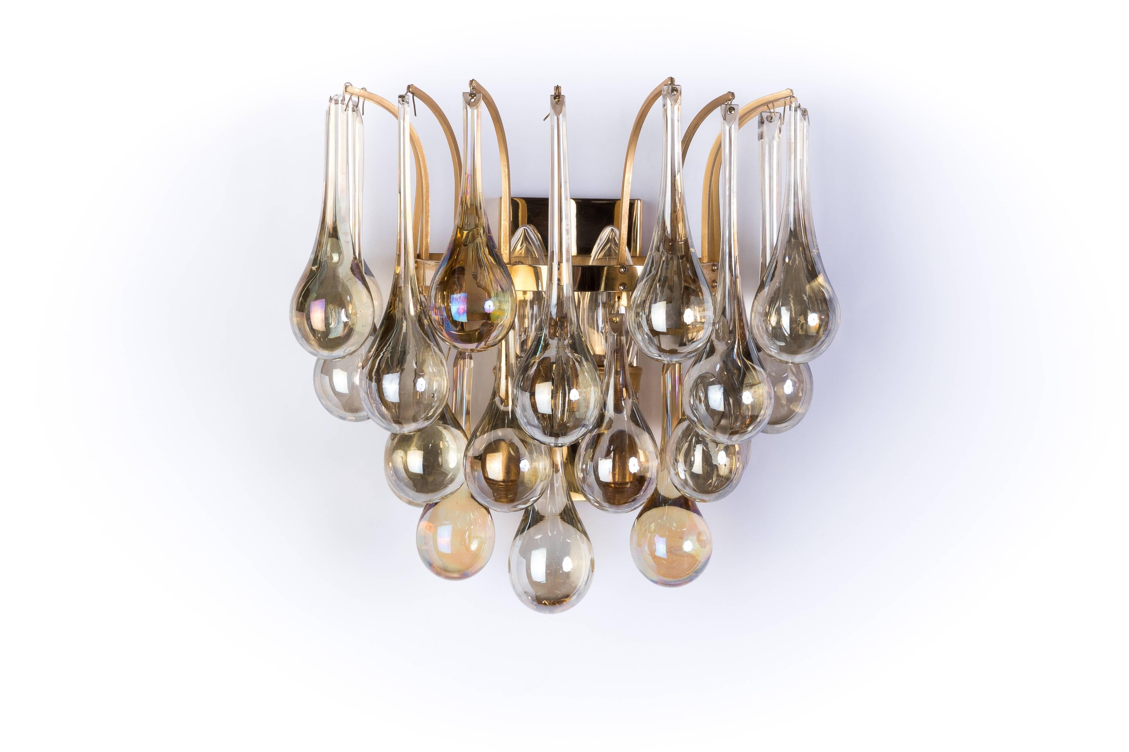 This exceptional Mid-Century Modernist pair of crystal sconces was designed by Christoph Palme. They feature a gilded metal frame layers of cascading crystal tears.

Made in Germany, circa 1970.

